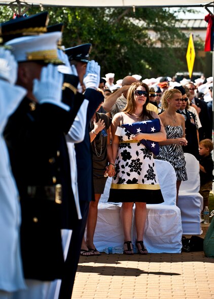 Emily Buras, widow of Senior Airman Michael Buras, reacts to the 21-gun salute during the Explosive Ordnance Disposal Memorial ceremony May 7 at Eglin Air Force Base, Fla.  Fifteen new names were added to the memorial wall this year.  The total, which includes all services, now stands at 269.  Airman Buras and Senior Airman Daniel Johnson were added to the Air Force wall. (U.S. Air Force photo/Samuel King Jr.)