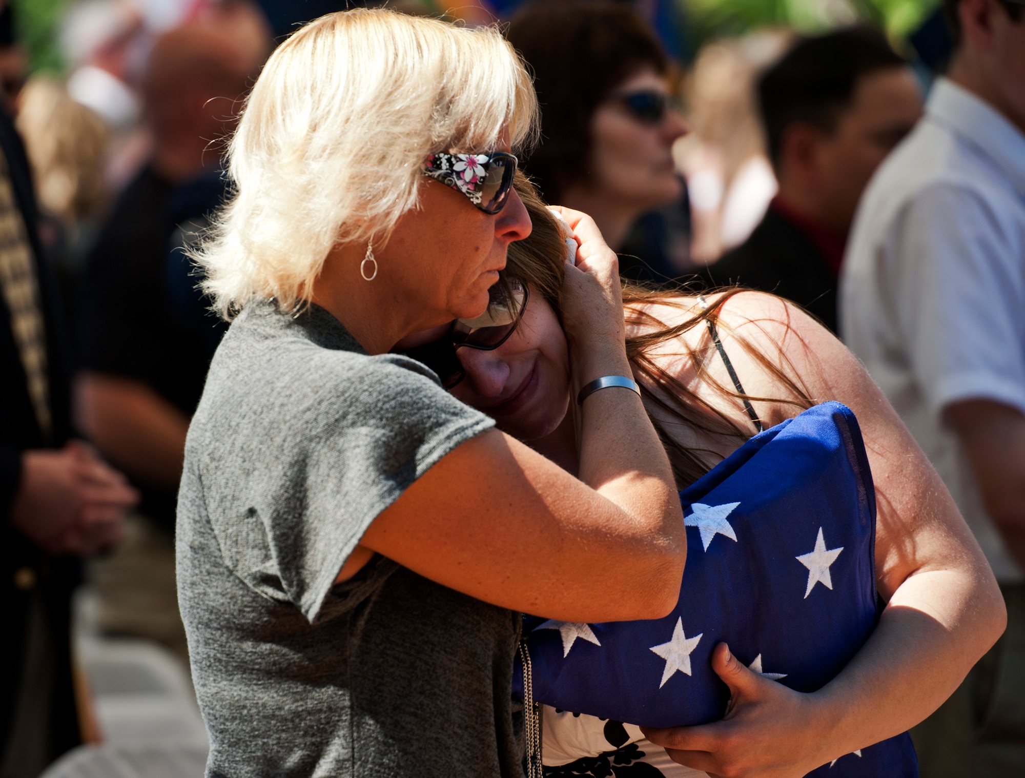 Joy Buras hugs her daughter-in-law Emily, widow of Senior Airman Michael Buras, after the Explosive Ordnance Disposal Memorial ceremony May 7 at Eglin Air Force Base, Fla.  Fifteen new names were added to the memorial wall this year.  The total, which includes all services, now stands at 269.  Airman Buras and Senior Airman Daniel Johnson were added to the Air Force wall. (U.S. Air Force photo/Samuel King Jr.)