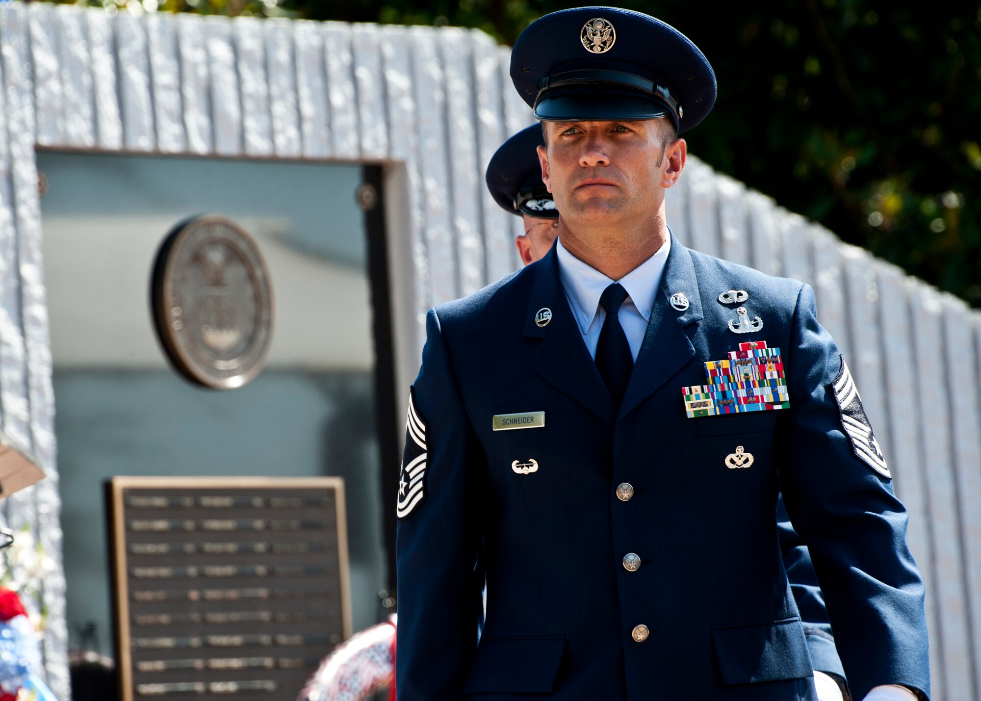 Chief Master Sgt. Albert Schneider and Maj. Jason Warnick, 366th Training Squadron Det. 3, move away from the memorial wall after laying a wreath in front of the Air Force wall during the explosive ordnance disposal memorial ceremony May 7 at Eglin Air Force Base, Fla.  Fifteen new names were added to the memorial wall this year.  The total, which includes all services, now stands at 269.  Airman Buras and Senior Airman Daniel Johnson were added to the Air Force wall. (U.S. Air Force photo/Samuel King Jr.)