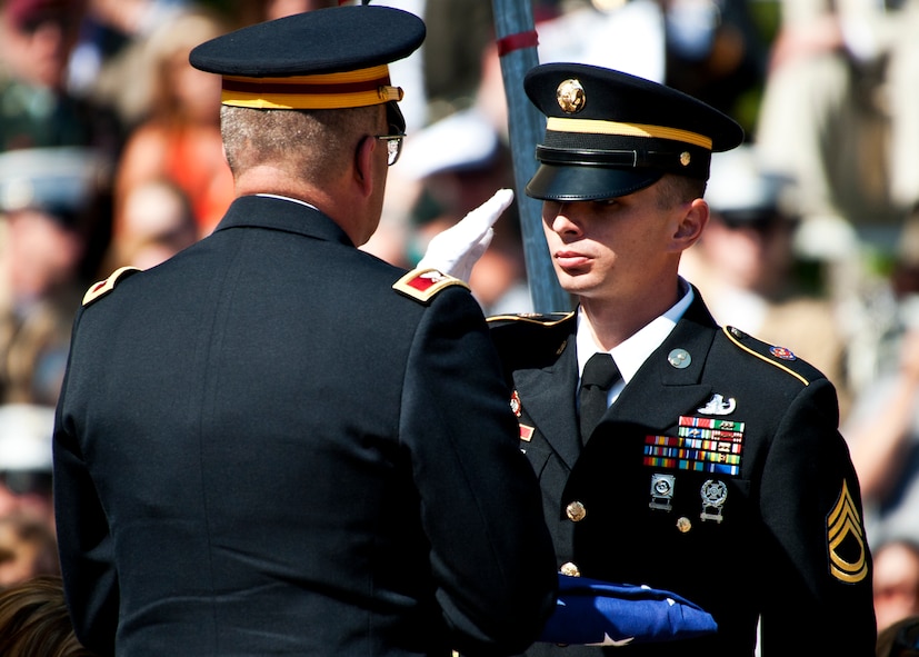 A Soldier salutes after presenting an American flag to a colonel during the Explosive Ordnance Disposal memorial ceremony May 7 at Eglin Air Force Base, Fla.  Fifteen new names were added to the memorial wall this year.  The total, which includes all services, now stands at 269. (U.S. Air Force photo/Samuel King Jr.)