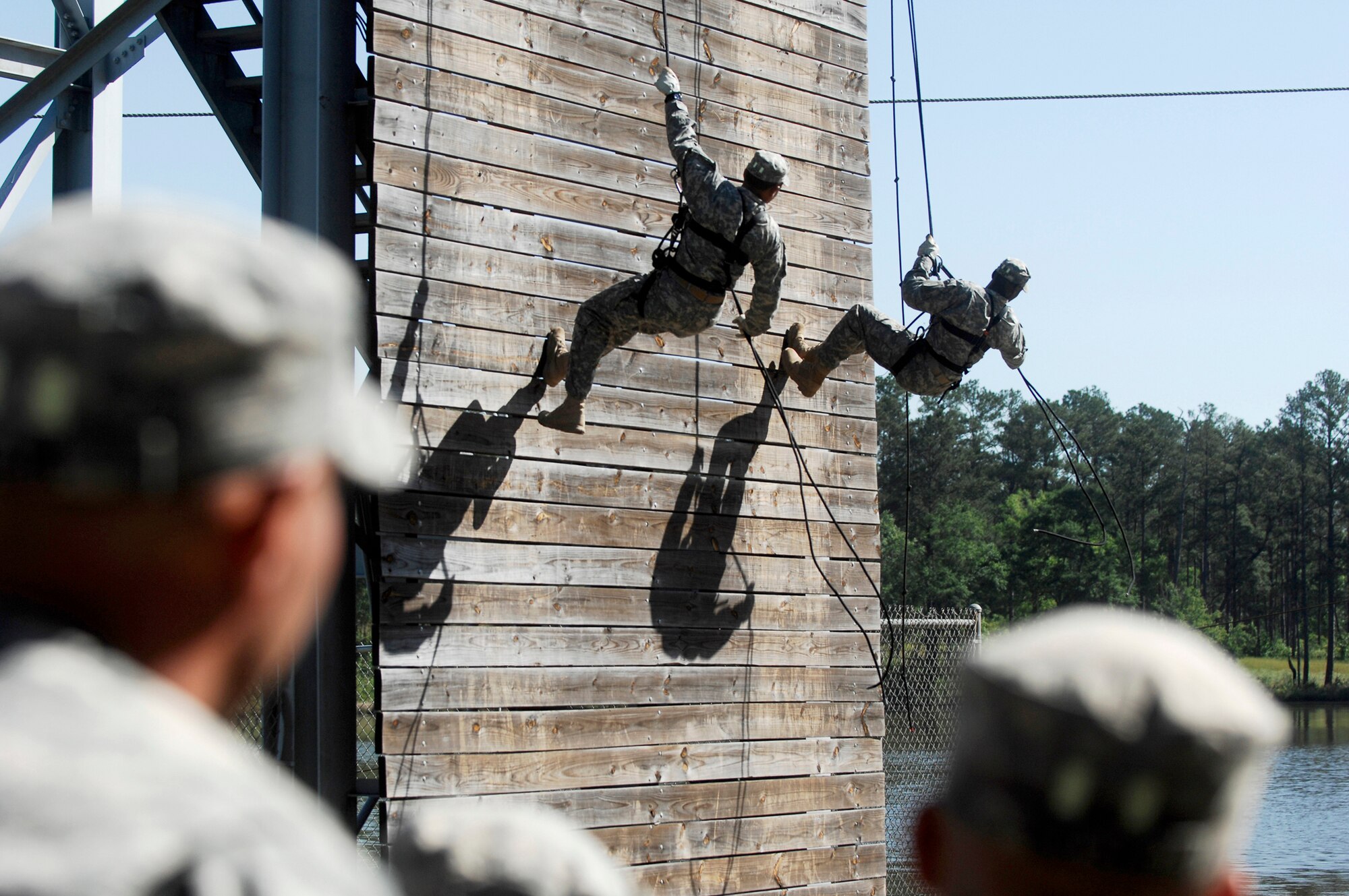 Two prior Ranger graduates from the Ranger Training Brigade demonstrate rappelling during a demonstration preceding the official graduation ceremony April 29, 2011, at Fort Benning, Ga. The audience also observed demolitions and hand-to-hand combat demonstrations as a way to understand what the servicemembers went through during the 61-day Ranger training course. Airman Garner is assigned to the 823rd Base Defense Squadron. (U.S. Air Force photo/Airman 1st Class Brigitte N. Brantley-Sisk)
