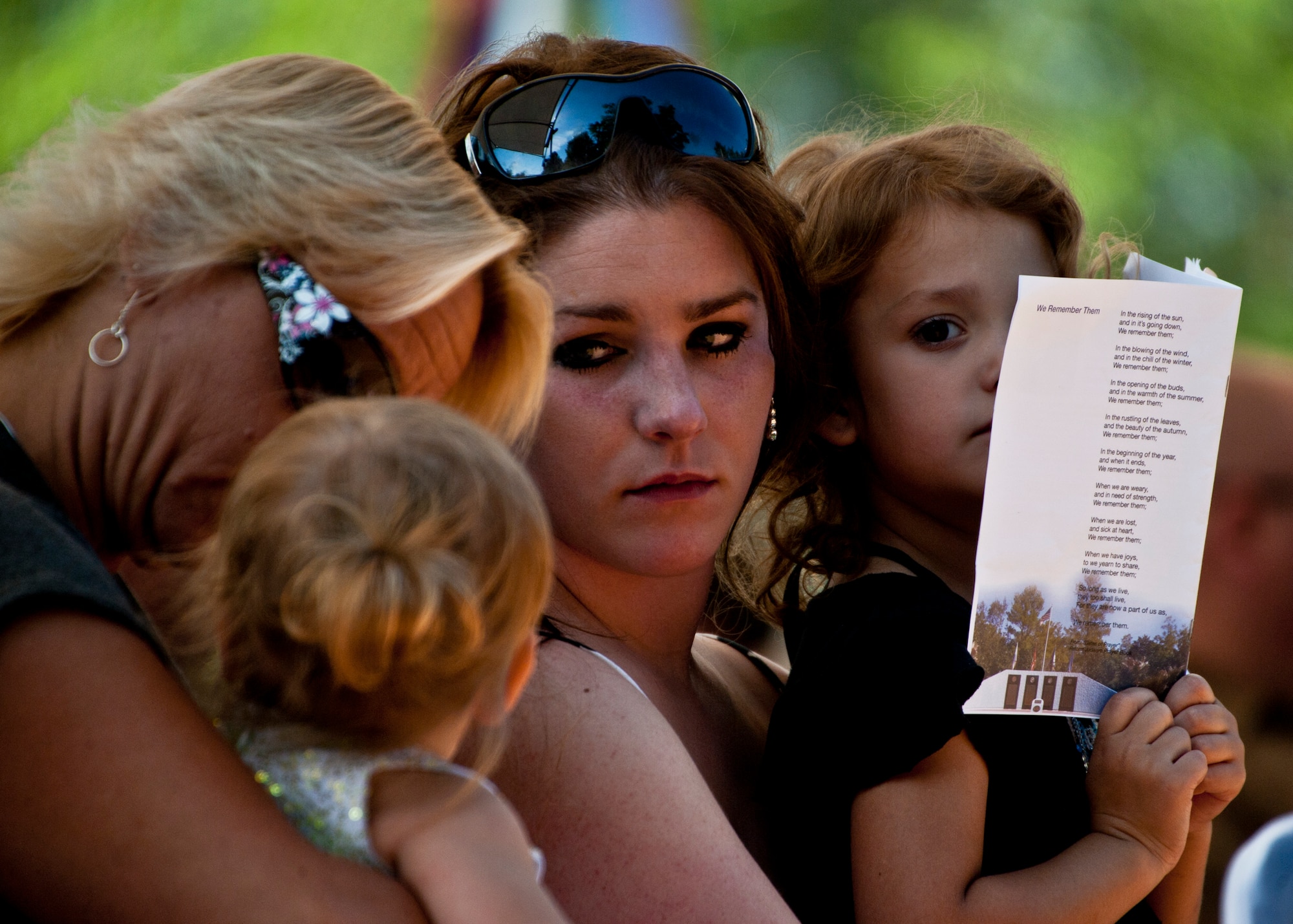 Emily Buras (middle), widow of Senior Airman Michael Buras, surrounds herself with family during the Explosive Ordnance Disposal Memorial ceremony May 7 at Eglin Air Force Base, Fla.  Fifteen new names were added to the memorial wall this year.  The total, which includes all services, now stands at 269. (U.S. Air Force photo/Samuel King Jr.)