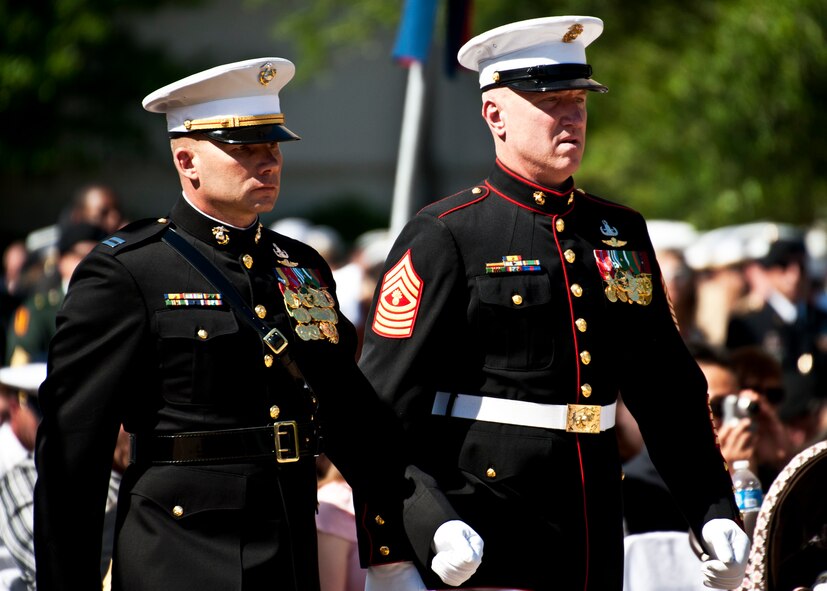 Capt. Schmidt and Gunnery Sgt. Carroll move toward the Explosive Ordnance Disposal memorial to lay a wreath in front of the Marine Corps wall during the ceremony May 7 at Eglin Air Force Base, Fla.  Fifteen new names were added to the memorial wall this year.  The total, which includes all services, now stands at 269.  The Marine Corps added eight names to the wall – Staff Sgt.s Adam Perkins, Joshua Cullins, Jordan Emrick, Gunnery Sgt.s Christopher Eastman, Floyd Holley, Justin Schmalstieg, Master Sgt. Daniel Fedder and Sgt. Jason Smith. (U.S. Air Force photo/Samuel King Jr.)