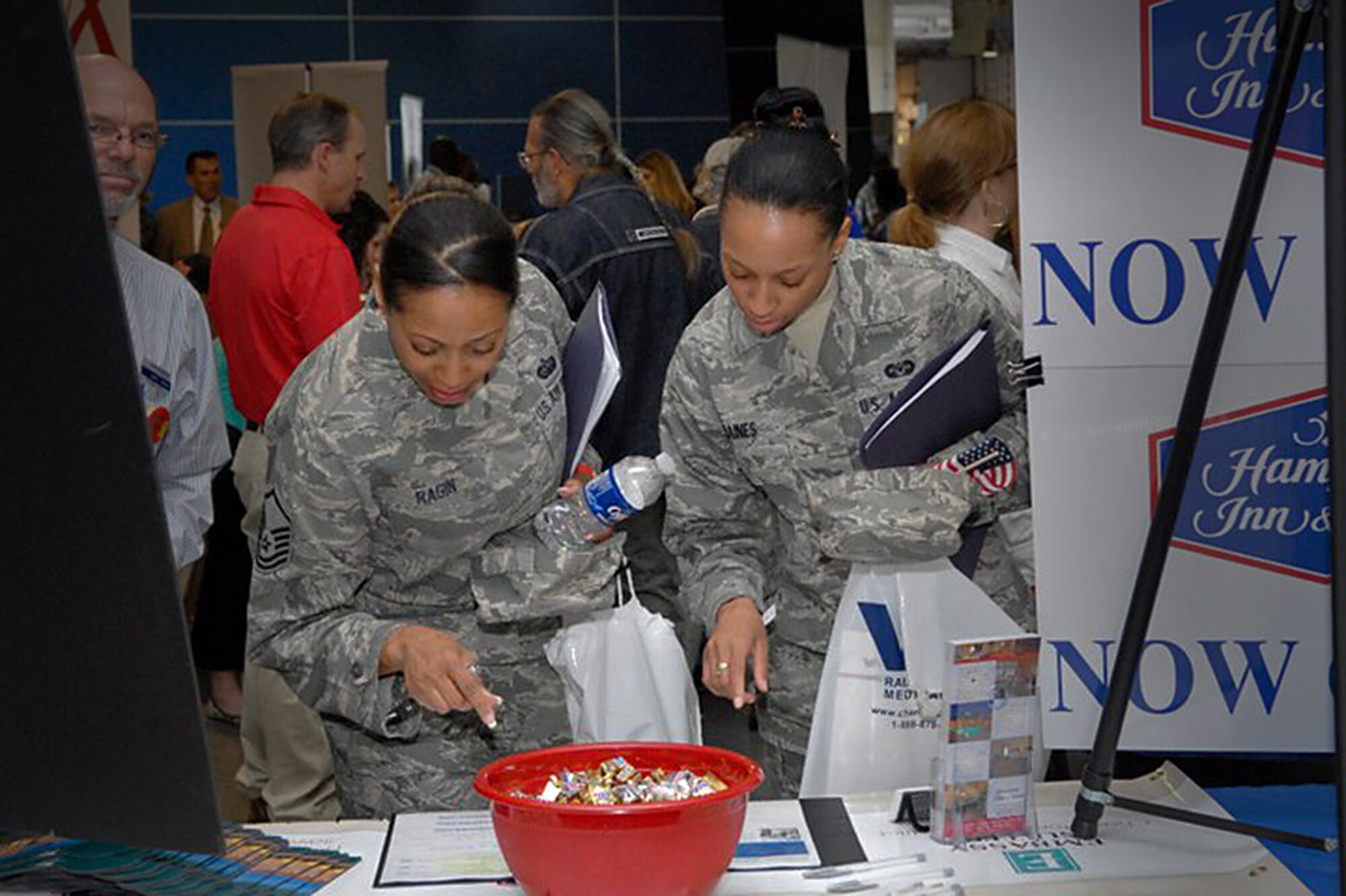 Master Sgt. Rose Ragin, 315th Aeromedical Evacuation Squadron,  and her daughter Senior Airman Tiffany Baines, 315th Airlift Wing Staff Judge Advocate’s Office, Browse the job fair part of the Charleston VA Welcome Home event aboard the USS Yorktown May 5, 2011 (Photo courtesy the Charleston VA)