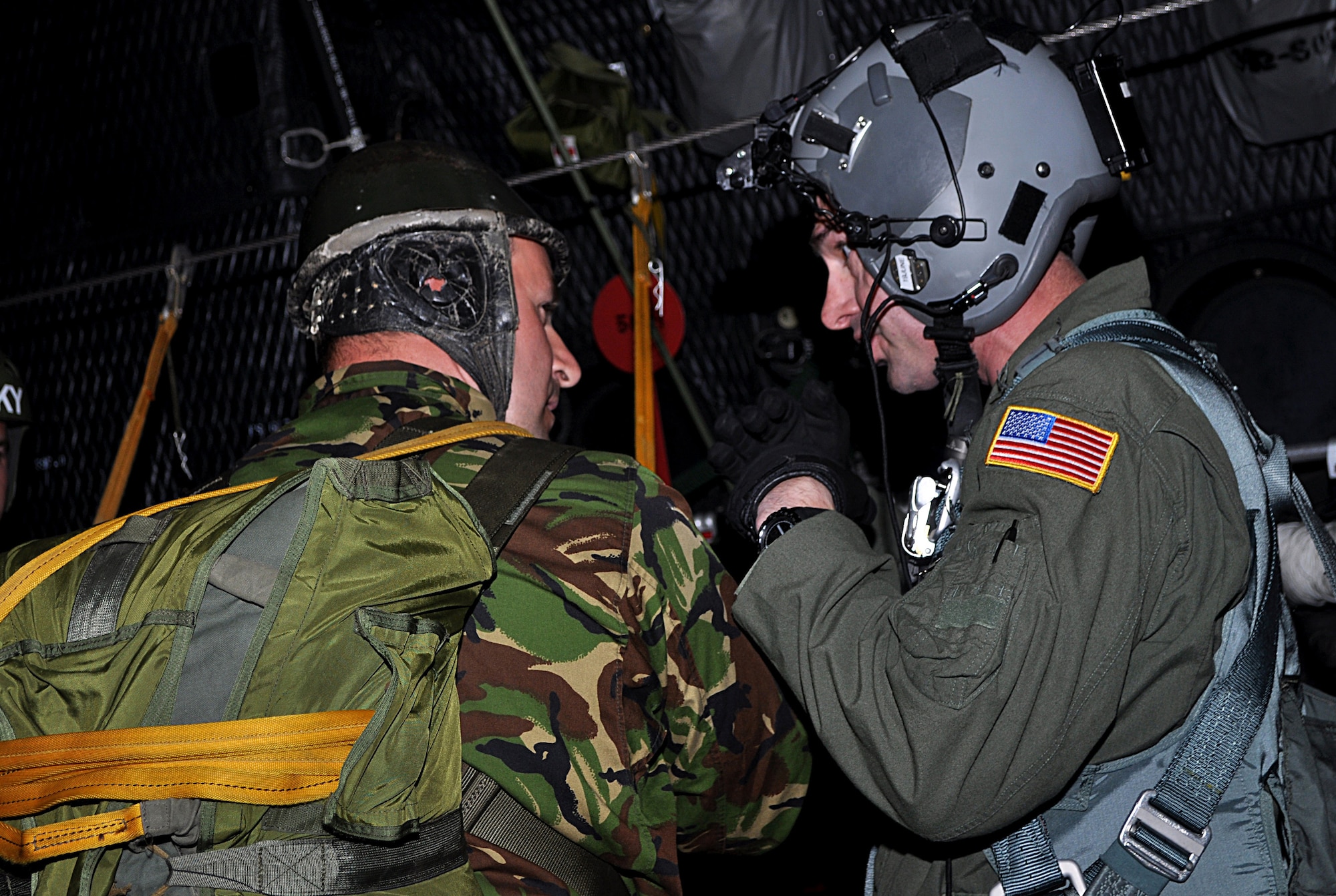 CONSTANTA, Romania -- A loadmaster from the 352nd Special Operations Group, RAF Mildenhall, England, gives a hand signal to a Romanian special operations forces member prior to a static line jump from a 352 SOG MC-130P Combat Shadow, April 29, 2011.  Members of the 352 SOG deployed to Romania for a partner-nation capacity-building exercise that included static line and high altitude low opening jumps.  The exercise ended May 5.  (U.S. Air Force photo by Tech. Sgt. Marelise Wood)