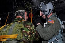 CONSTANTA, Romania -- A loadmaster from the 352nd Special Operations Group, RAF Mildenhall, England, gives a hand signal to a Romanian special operations forces member prior to a static line jump from a 352 SOG MC-130P Combat Shadow, April 29, 2011.  Members of the 352 SOG deployed to Romania for a partner-nation capacity-building exercise that included static line and high altitude low opening jumps.  The exercise ended May 5.  (U.S. Air Force photo by Tech. Sgt. Marelise Wood)