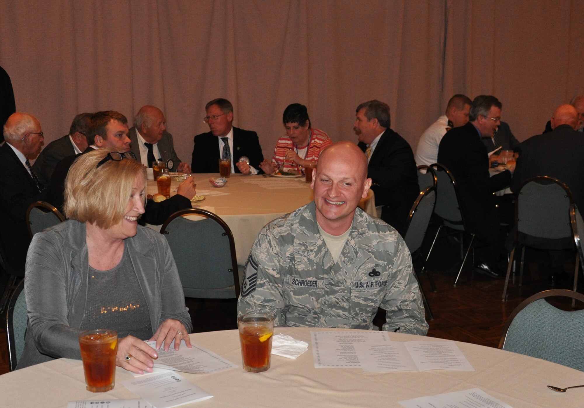 WRIGHT-PATTERSON AIR FORCE BASE, Ohio – Senior Master Sgt. Luke Schroeder, 445th Maintenance Squadron, enjoys a conversation with Clark State University president and Springfield Rotary Club member Dr. Karen Rafinski during the 30th Annual Armed Forces Day luncheon May 3. More than 235 people attended the luncheon sponsored by the Springfield Rotary Club, Springfield Kiwanis Club, Springfield Exchange Club and the Miami Valley Military Affairs Association, is held annually to recognize and honor area military units, installations and assigned personnel who serve the Springfield-Clark County community, the State of Ohio and the United States. (U.S. Air Force photo/Lt. Col. Cynthia Harris)