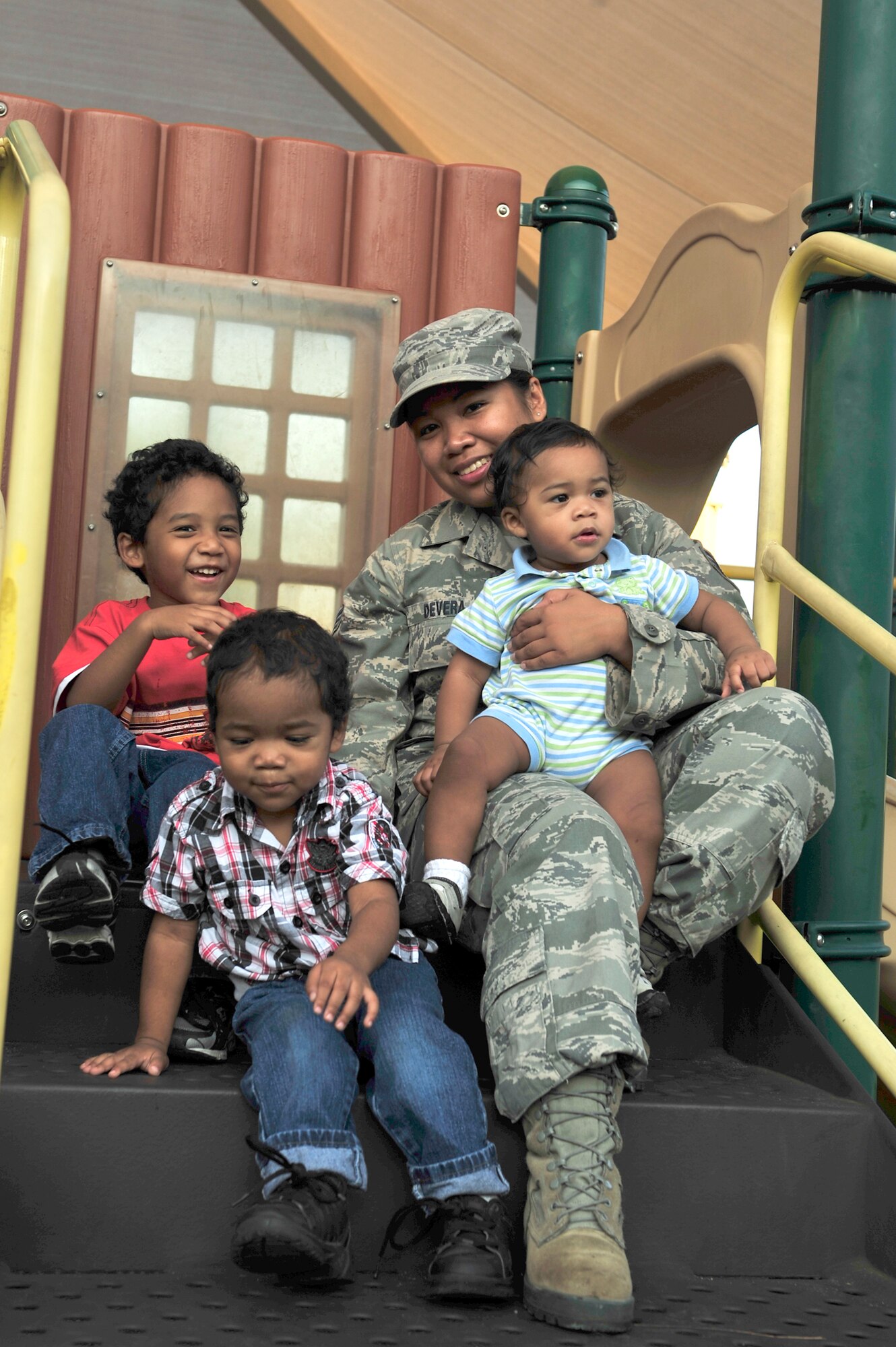 Senior Airman Sheila deVera gathers with her three sons, left to right, Brian Jr., Daeshawn, and Jaiden, Sept. 15, 2011, at a playground at Hurlburt Field, Fla. Airman deVera is a photographer assigned to the 1st Special Operations Wing. (U.S. Air Force photo/Staff Sgt. Stephanie Jacobs)