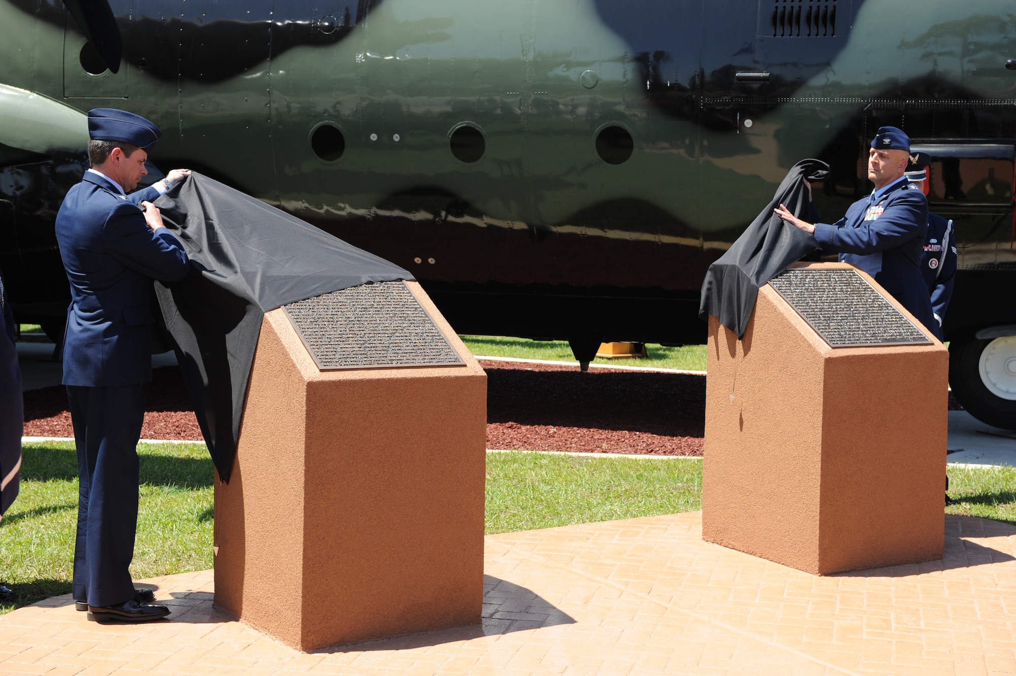 Col. Michael T. Plehn, 1st Special Operations Wing commander, and Col. Anthony J. Comtois, 919th Special Operations Wing commander, unveil two plaques containing background information on the MC-130E Combat Talon I, tail number 64-0567, and on all MC-130E Combat Talon I aircraft, May 6, 2011, Hurlburt Field, Fla. The event was part of a ceremony to dedicate the aircraft to the Hurlburt Field Airpark. (Air Force photo by Airman 1st Class Caitlin O'Neil-McKeown/RELEASED)