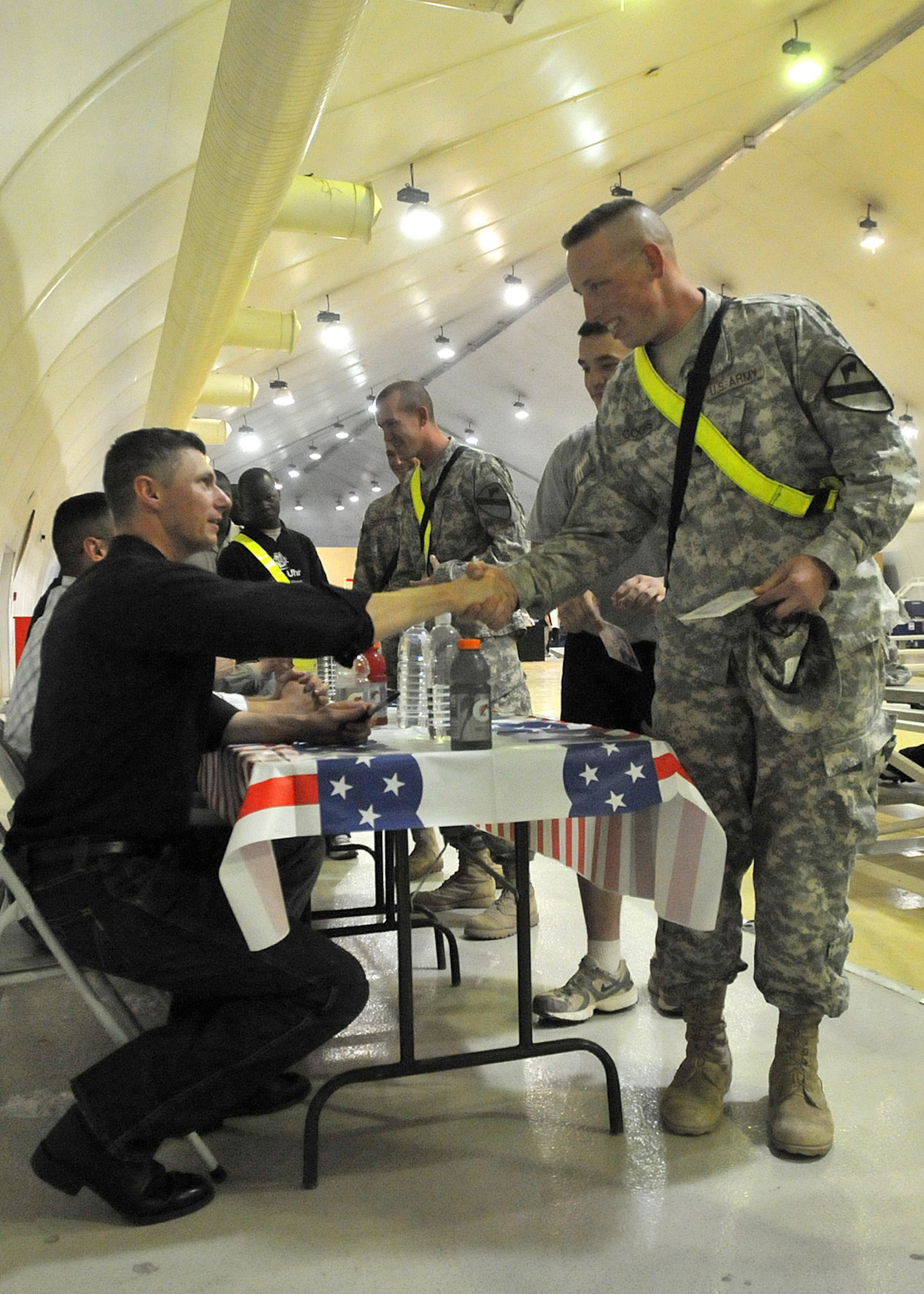 CONTINGENCY OPERATING SITE MAREZ, Iraq – Spc. Matthew Coons, a motor transport operator assigned to Forward Support Company E, 2nd Battalion, 7th Cavalry Regiment, 4th Advise and Assist Brigade, 1st Cavalry Division, thanks Air Force Tech Sgt. Stephen Brannen, guitarist and vocalist of the U.S. Air Force’s Central band, “Wild Blue Country,” after the group performed for deployed Fort Hood troopers at the Contingency Operating Site Marez main gymnasium, April 29, 2011. Coons, a native of Tipton, Mo., and other 4th AAB troopers gave the Air Force band a standing ovation after the live performance. (U.S. Army photo by Spc. Terence Ewings, 4th AAB PAO, 1st Cav. Div., USD-N)