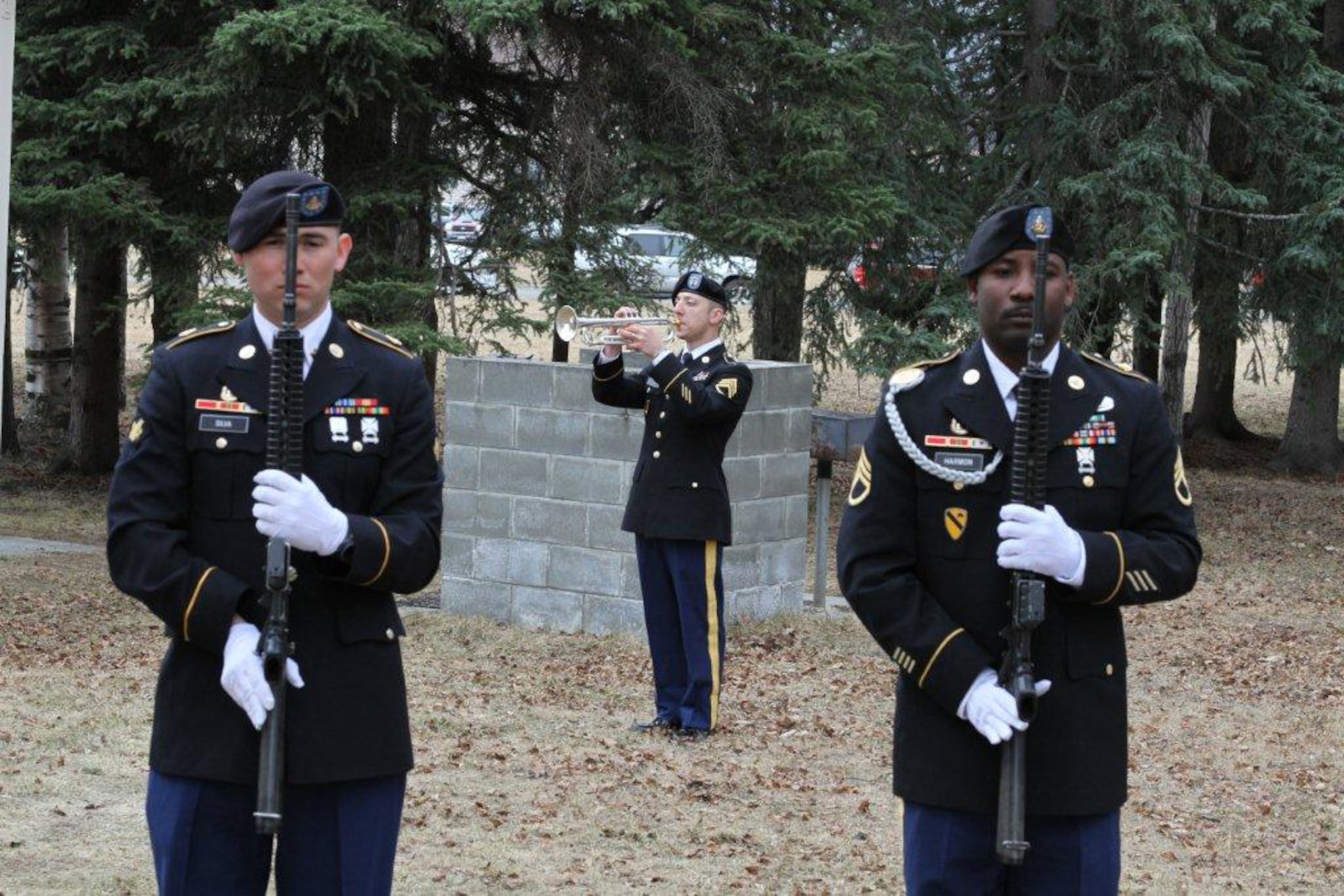 Framed by Soldiers of the 3rd Maneuver Enhancement Brigade Honor Guard, 9th Army Band bugler Army Staff Sgt. Alton Huckabee plays ?Taps,? Tuesday, in the Soldiers? Chapel courtyard to honor Army Capt. Charles Ridgley, 17th Combat Sustainment Support Battalion. Ridgley was on of five service members killed, April 16, when an Afghan Soldier working as a Taliban sleeper agent, set off multiple grenades in Nangarhar Province, Afghanistan. Ridgley had served nearly twenty years in the Army, having served previously as an enlisted Soldier. (Photo by Sgt. Tamika Dillard/3rd MEB PA)