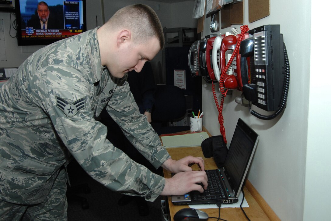 Senior Airman Daniel Lecureaux, a Command Post Controller for the 127th Wing at Selfridge ANGB, Mich. updates the daily events log during operations in the base Command Post.  SrA Lecureaux was named the 2011 Command Post Airman of the of the Year for the Air National Guard during a national training conference for Command and Control.  (USAF Photo by Rachel Barton) (Released)