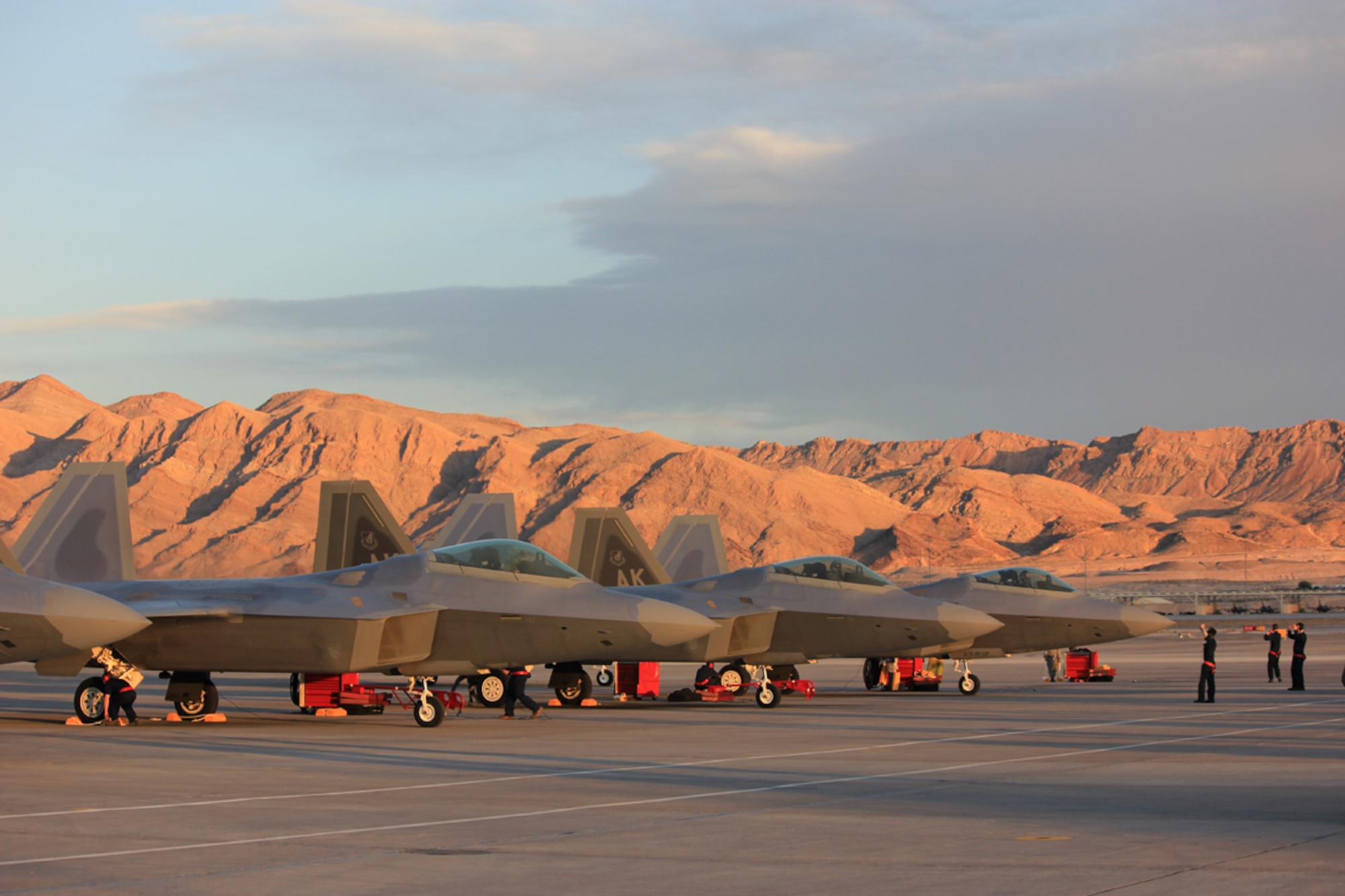 F-22s of the 90th Fighter Squadron rest under a desert backdrop. (U.S. Air Force photo\Master Sgt. Erik Wilson)