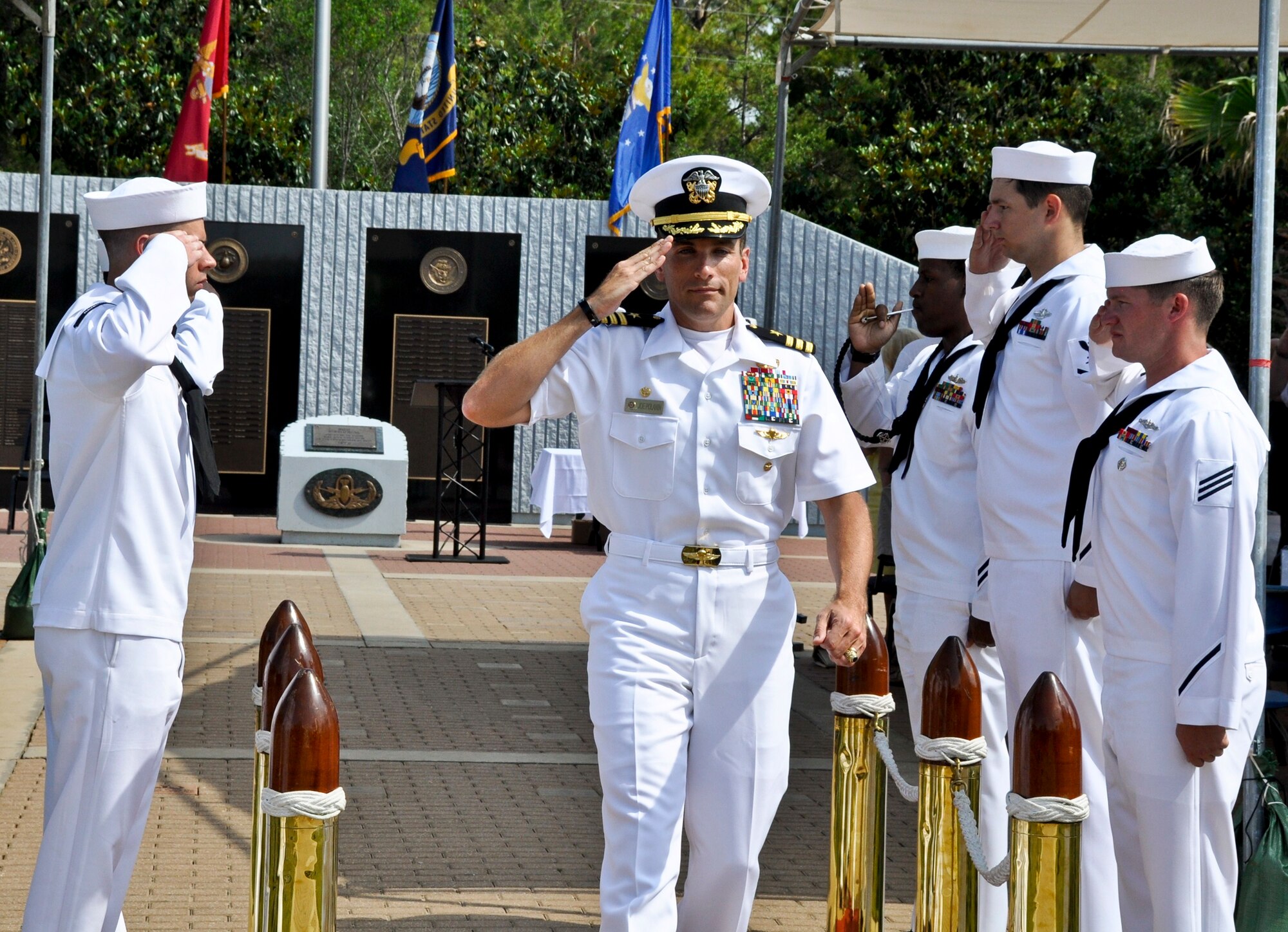 Commander Joseph Polanin returns a salute from his Sailors as he exits his change of command ceremony. Commander Polanin assumed command from Capt. Adam Guziewicz May 9.  The ceremony marked the 25th change of leadership since the school's establishment in 1941. (USAF photo/Lois Walsh)