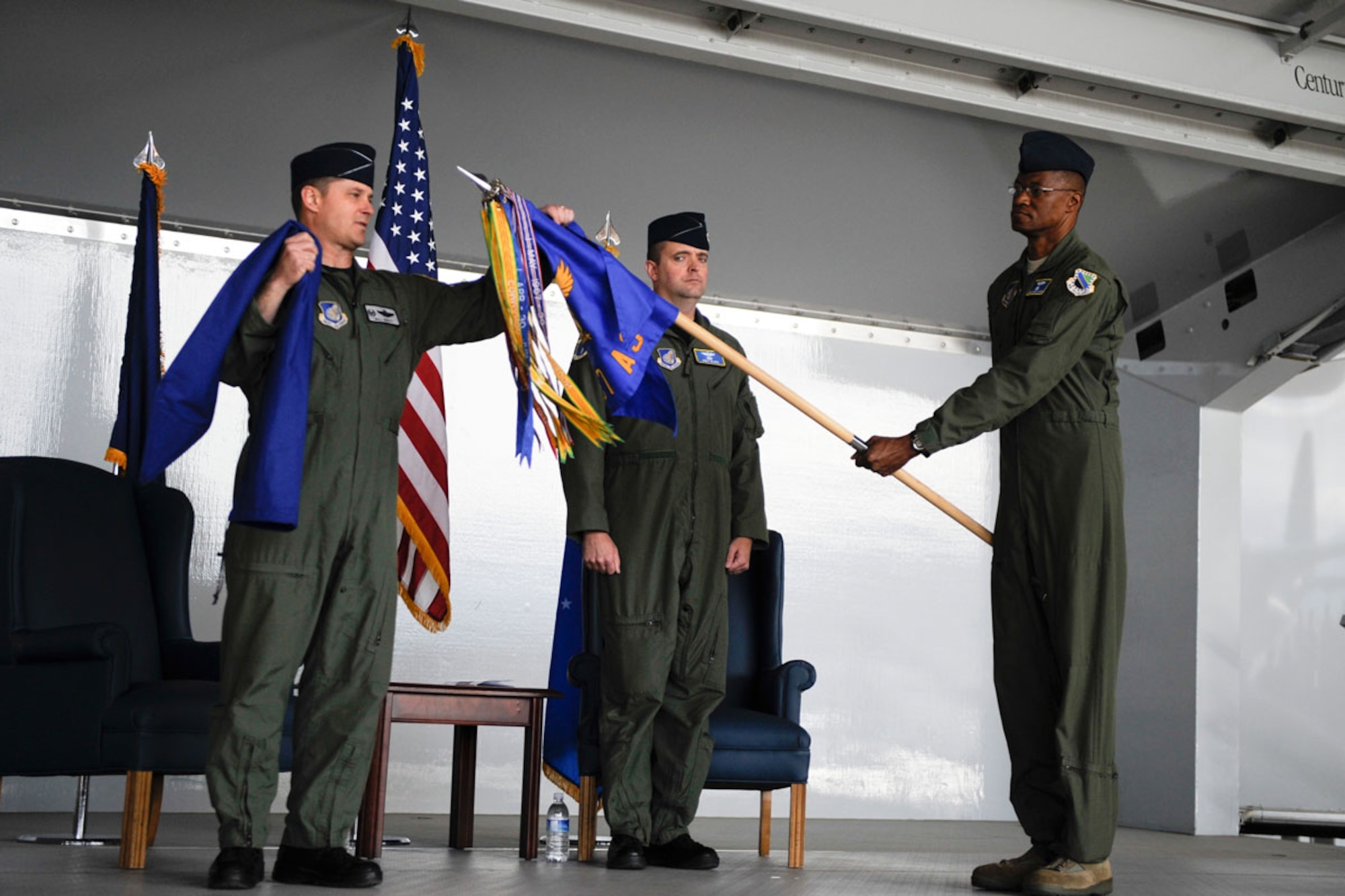 Air Force Col. William Routt, 3rd Operations Group commander, unfurls the 537th Airlift squadron guidon held by Senior Master Sgt. Steve Vaughn, as Air Force Lt. Col. Thomas McGee, 537th AS commander, looks on during the unit’s activation ceremony, April 29. (U.S. Air Force photo\Steve White)