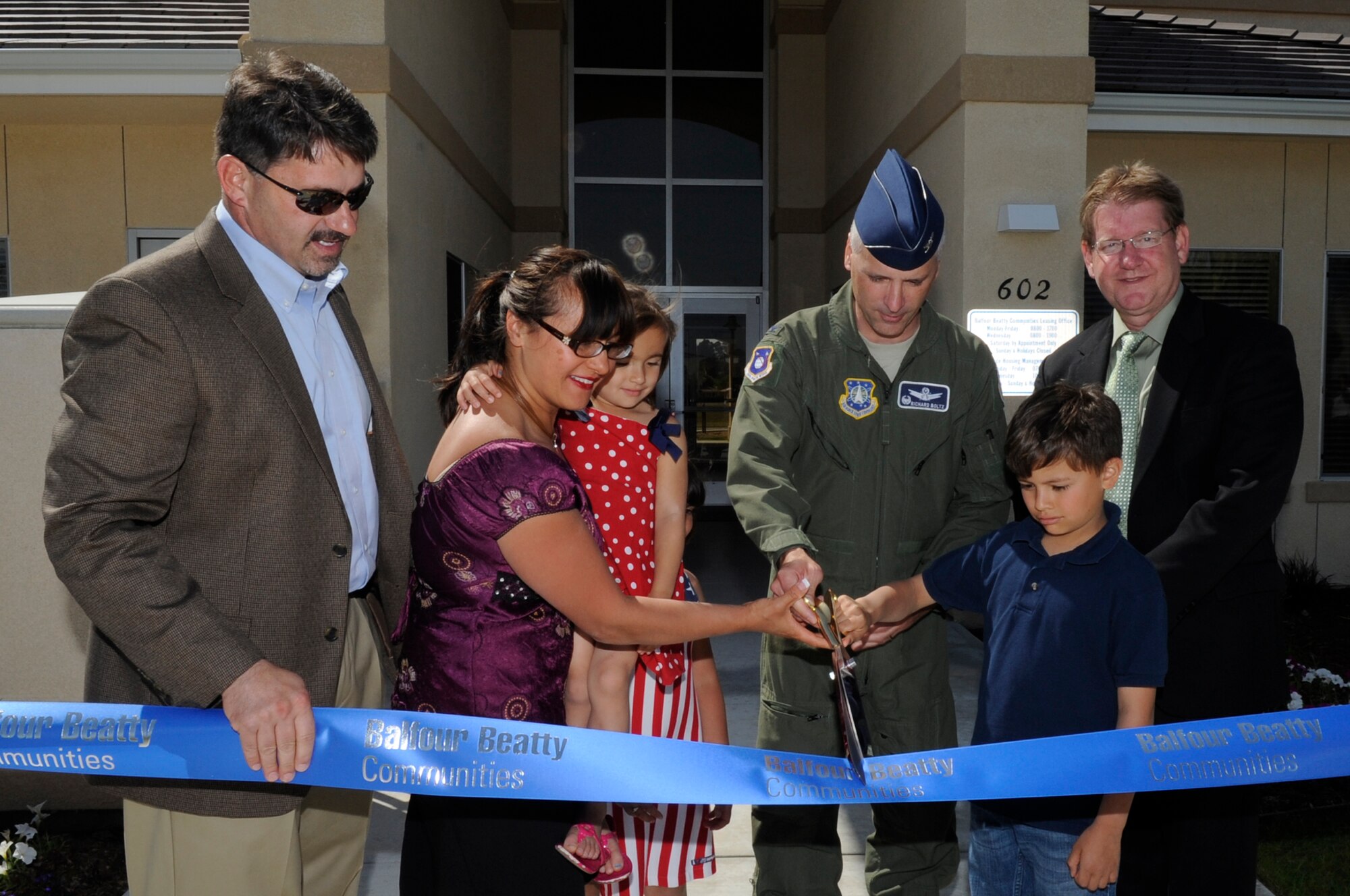 VANDENBERG AIR FORCE BASE, Calif. - Cutting the ribbon, Col. Richard Boltz, the 30th Space Wing commander, and the Faulkenberry family, officially open the new base Community Center here Friday, May 6, 2011.   The Fualkenberry family was selected by Balfour Beatty Communities to open the base Community Center.  (U.S. Air Force photo/Senior Airman Lael Huss)