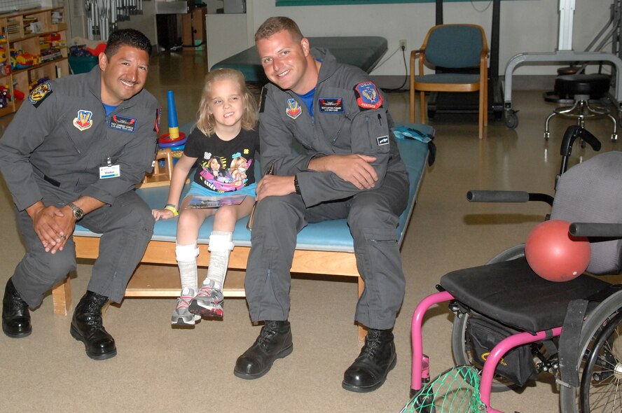 Tech. Sgt. Lorenzo Garcia and Staff Sgt. Matthew Turner, A-10 demonstration team crew members, visit with Macie Bigbee, age 9, at the Shriners Hospital for Children in Shreveport, La. The demo team visited the children May 6 prior to the 2011 Defenders of Liberty Air Show. (U.S. Air Force photo/Senior Airman Allison M. Boehm)(RELEASED) 