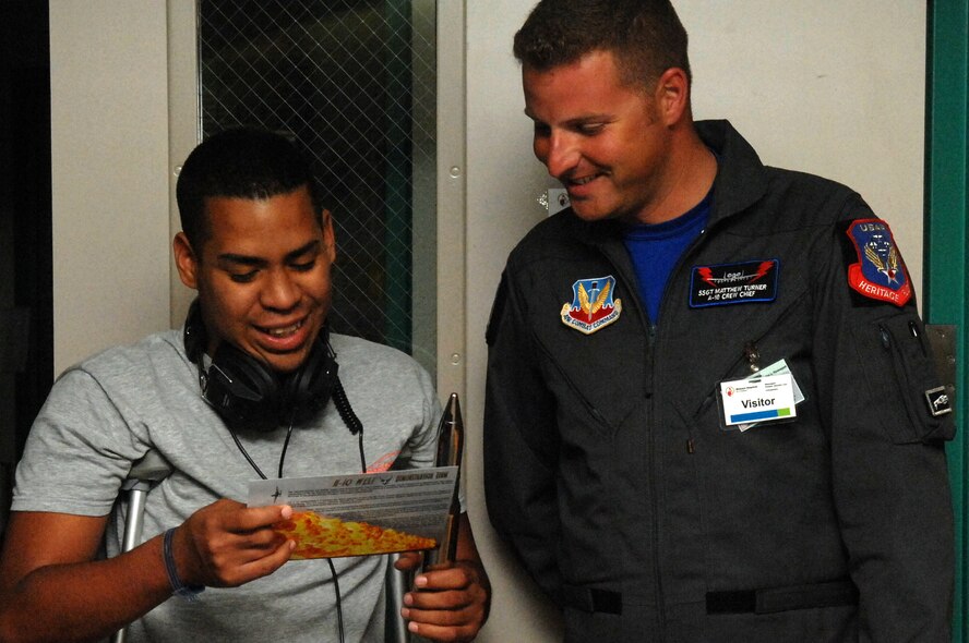 Staff Sgt. Matthew Turner, A-10 demonstration team crew member, shows Edgar Perryman, age 16, a bullet from the A-10 aircraft. Sergeant Turner visited children at the Shriners Hospital for Children in Shreveport, La. May 6 prior to the 2011 Defenders of Liberty Air Show. (U.S. Air Force photo/Senior Airman Allison M. Boehm)(RELEASED) 