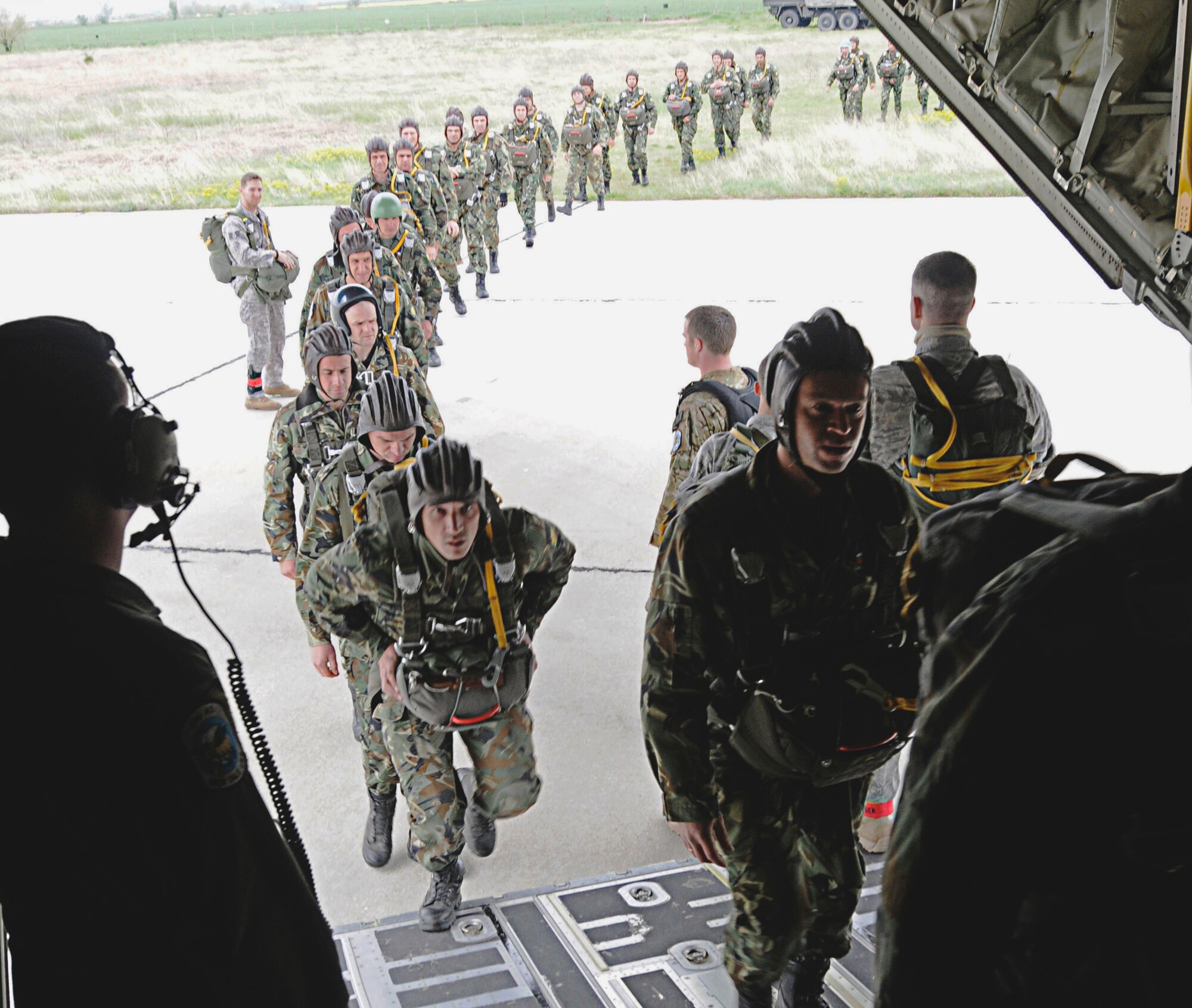 Members from the 435th Security Forces Squadron usher in more than 50 Bulgarian air force paratroopers into a C-130J Super Hercules April 29, 2011, in support of Thracian Spring 2011, in Plovdiv, Bulgaria. (U.S. Air Force photo/Airman 1st Class Desiree W. Esposito)