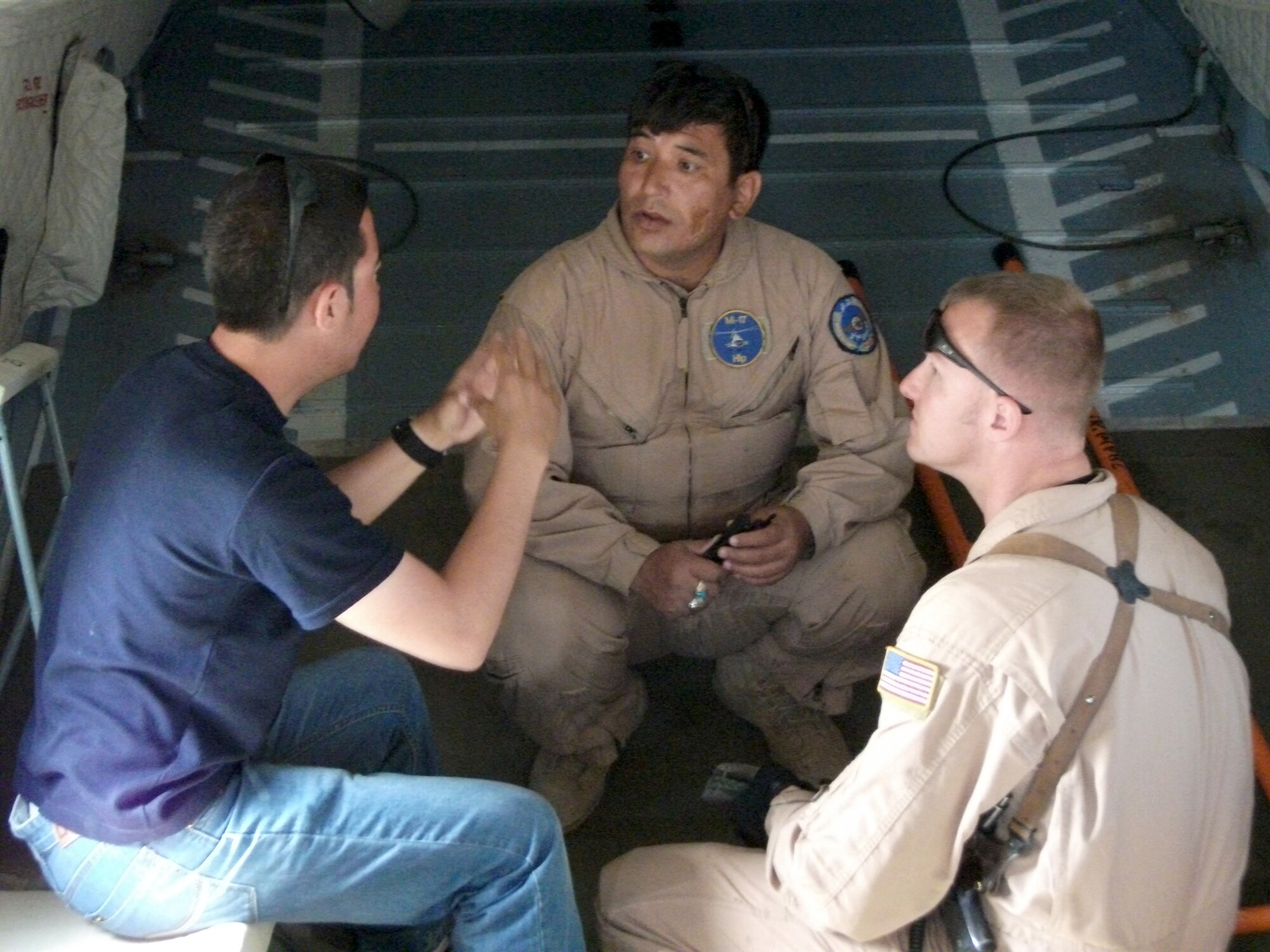 Staff Sgt Bryan Costerisan discusses preflight procedures with Afghan air force instructor flight engineer Abdul Wahid. Seven Afghan Mi-17 instructors graduated May 4, 2011, from the first Mi-17 "Train the Trainer" upgrade course taught by AAF and U.S. Air Force instructors at the Afghanistan Premier Flight Training Center at Shindad Air Base, Afghanistan. Sergeant Costerisan is a 444th Air Expeditionary Advisory Squadron adviser. (U.S. Air Force courtesy photo)

