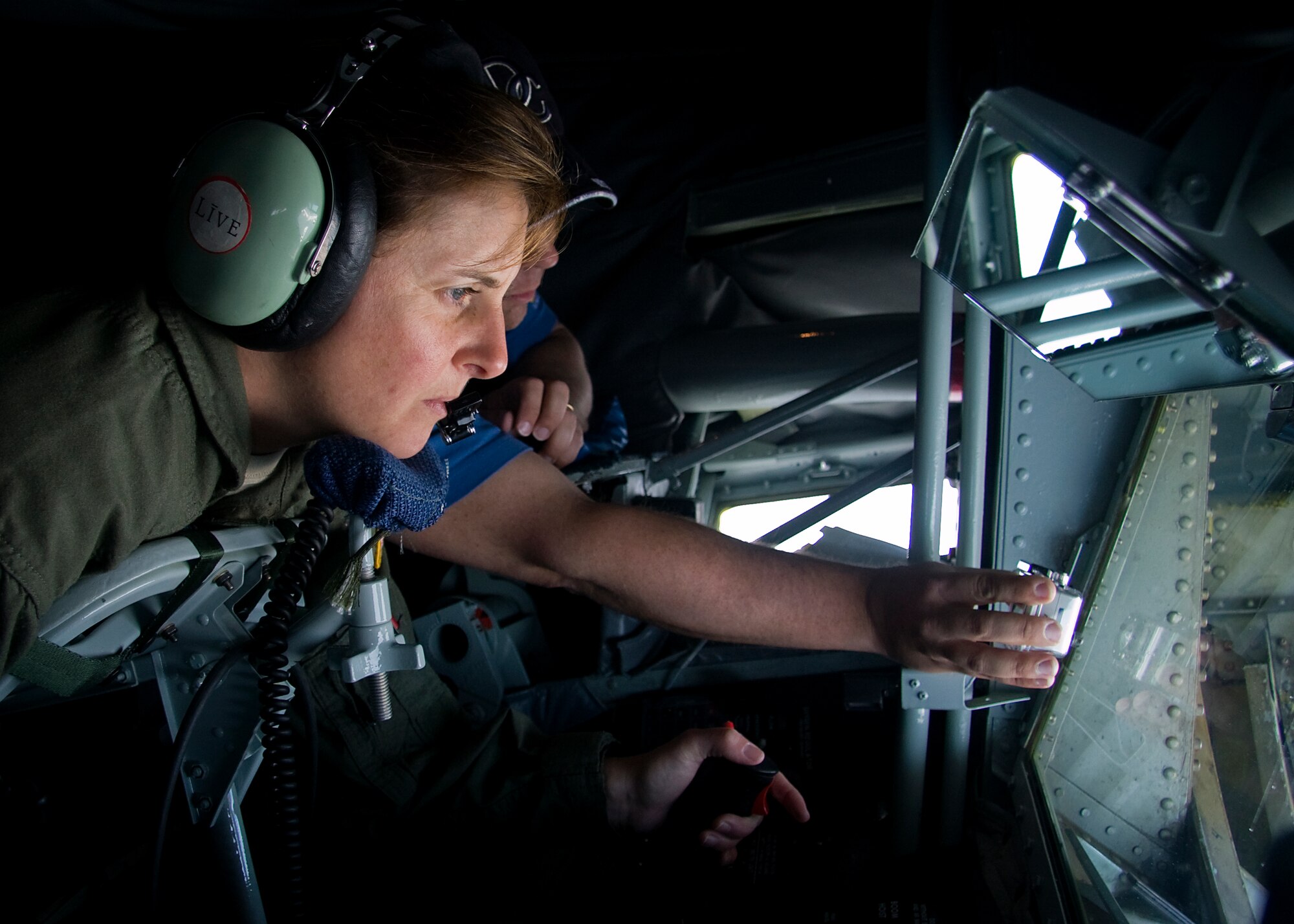 GRISSOM AIR RESERVE BASE, Ind. -- Senior Master Sgt. Laura McKee refuels a U.S. Navy E-6 as Scott Allen takes photos of the refueling during a media orientation flight May 5. Sergeant McKee is an in-flight refueling instructor with the 72nd Air Refueling Squadron and Mr. Allen is a photojournalist with WTHR in Indianapolis. During the flight 13 new and traditional media representatives were able to witness firsthand the mission of the 434th Air Refueling Wing. (U.S. Air Force photo/Tech. Sgt. Mark R. W. Orders-Woempner)
