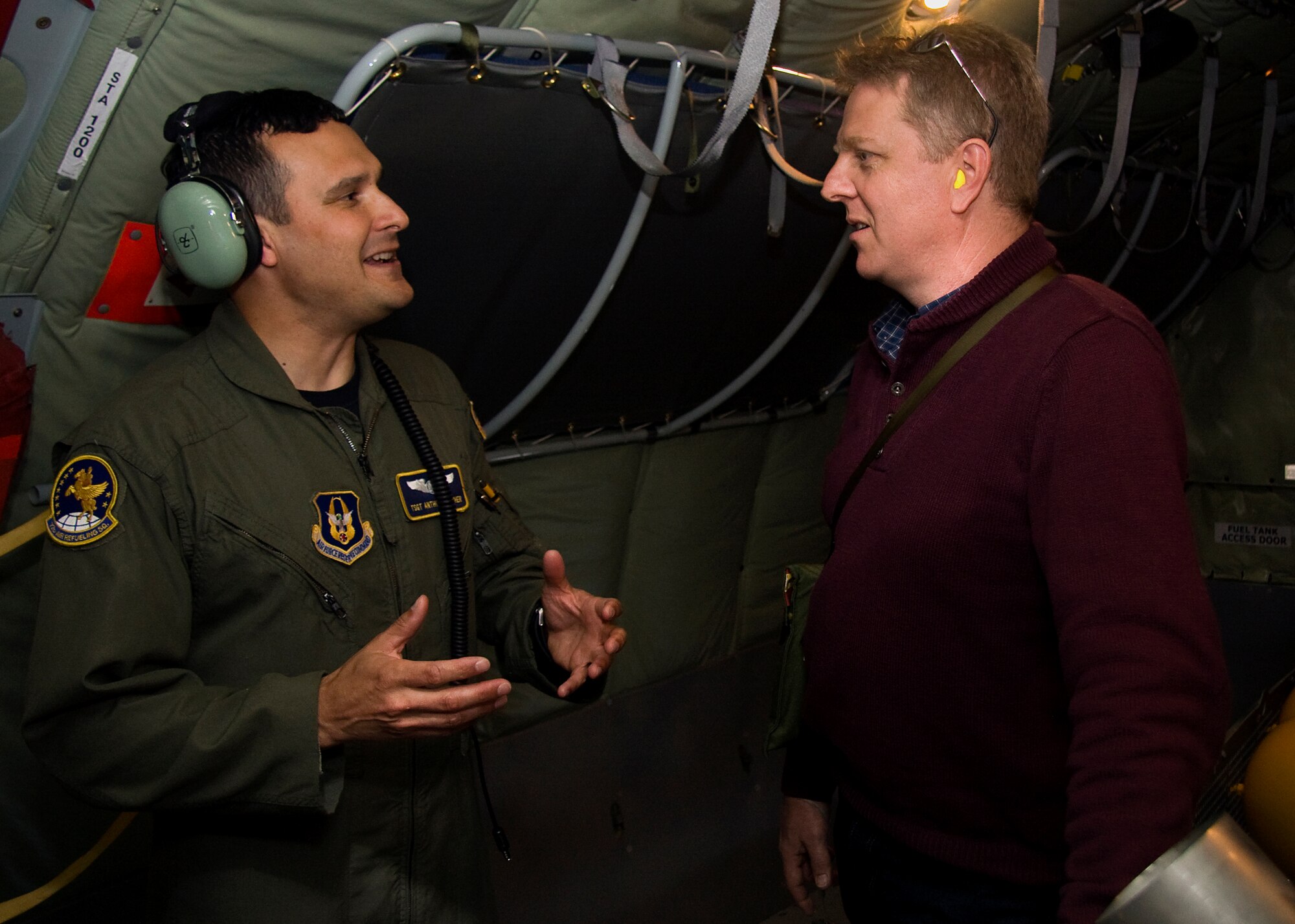 GRISSOM AIR RESERVE BASE, Ind. -- Tech. Sgt. Anthony Krisher, 72nd Air Refueling Squadron in-flight refueling technician, discusses his role and experiences in the Air Force Reserve with Jamie Till during a media orientation flight onboard one of Grissom's KC-135R Stratotankers May 5. During the flight 13 new and traditional media representatives were able to witness firsthand the mission of the 434th Air Refueling Wing as the 72nd ARS crew refueled a U.S. Navy E-6 from Tinker Air Force Base, Okla. Mr. Till is a managing partner with Flight Line Radio, an internet radio station dedicated to aviation related topics. (U.S. Air Force photo/Tech. Sgt. Mark R. W. Orders-Woempner)

