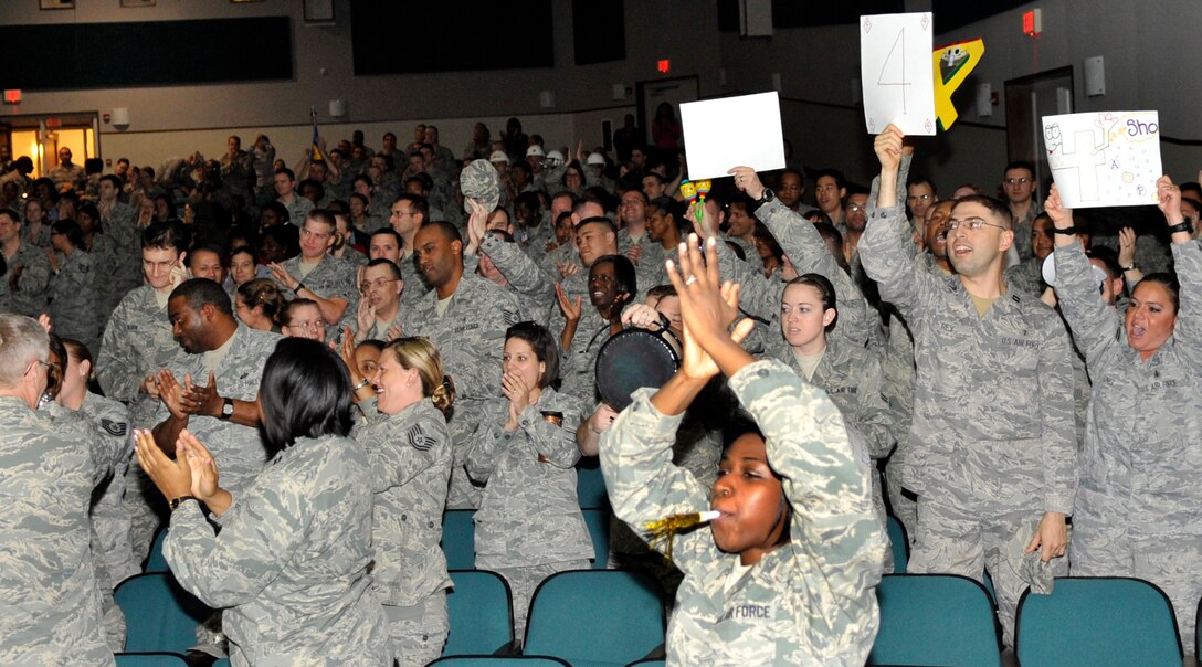 Members of the 779th Medical Group celebrate with enthusiasm after hearing they received an "Outstanding" result on the Health Services Inspection during the HSI outbrief Friday, May 6. An Outstanding rating indicates performance or operation far exceeds mission requirements. (U.S. Air Force photo/Senior Airman Laura Turner)