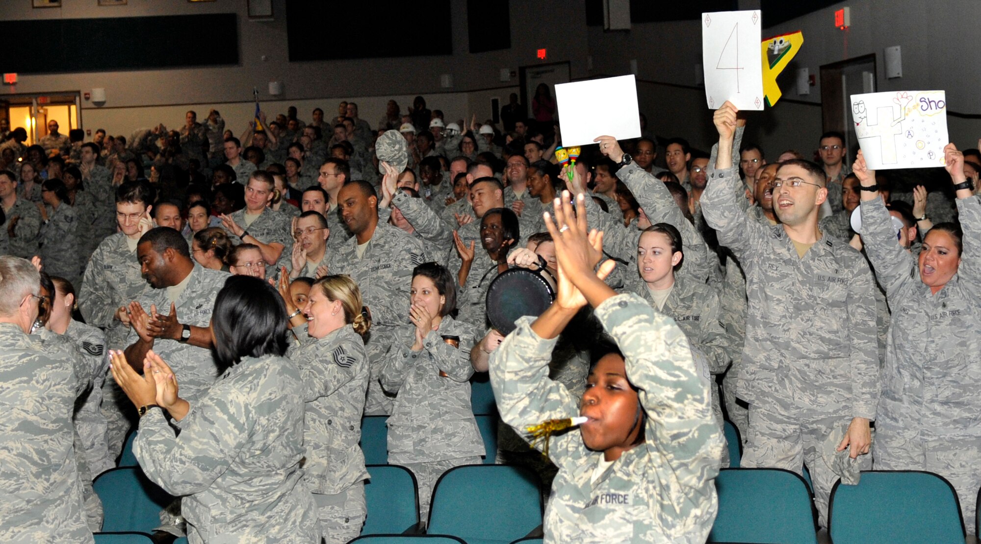 Members of the 779th Medical Group celebrate with enthusiasm after hearing they received an "Outstanding" result on the Health Services Inspection during the HSI outbrief Friday, May 6. An Outstanding rating indicates performance or operation far exceeds mission requirements. (U.S. Air Force photo/Senior Airman Laura Turner)