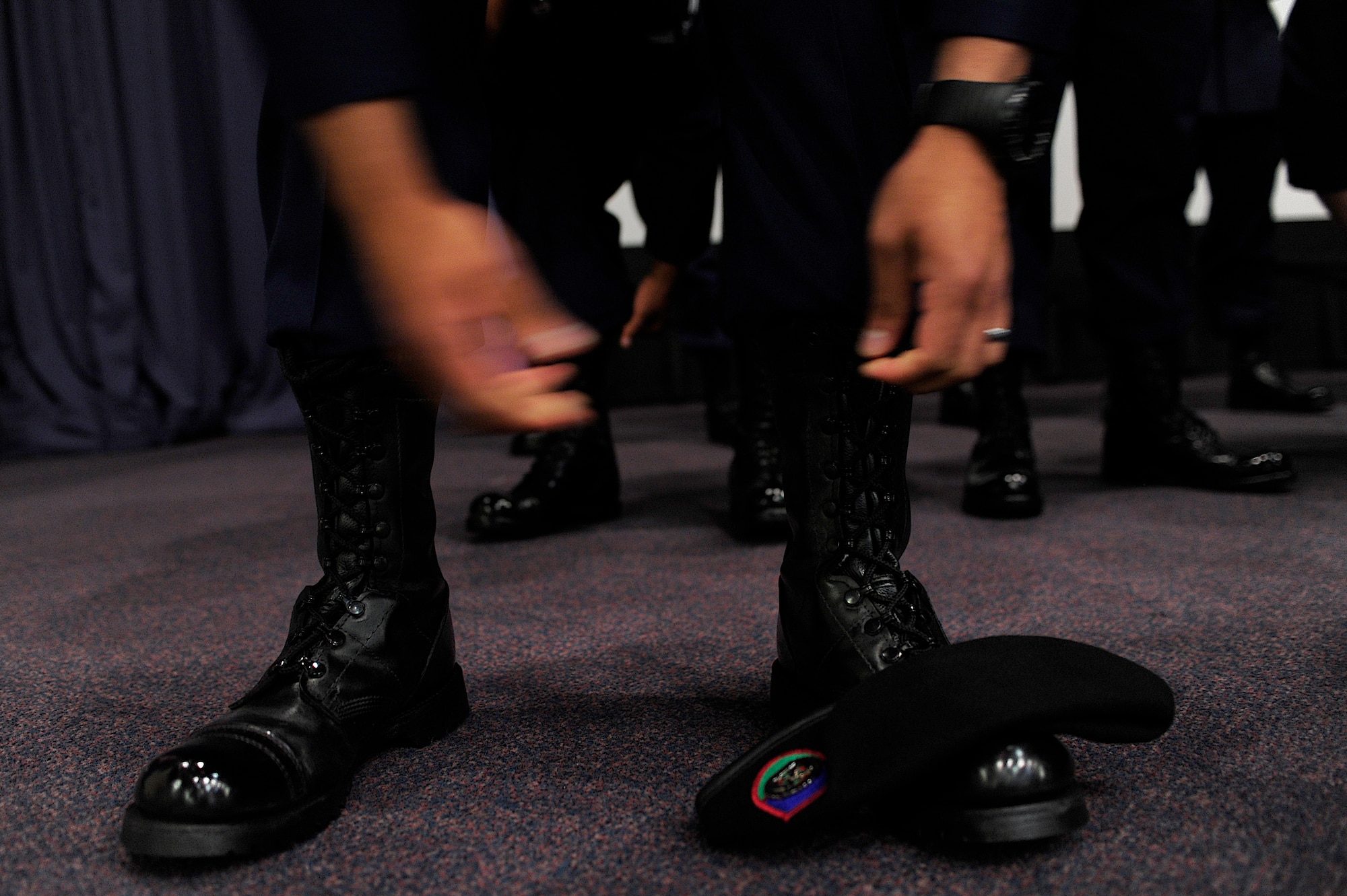 U.S. Air Force Staff Sgt. John Gonzales, 342nd Training Squadron Detachment 3 class Falcon 86, blouses his boots during the Tactical Air Control Party graduation ceremony, Hurlburt Field, Fla., May 3, 2011. Of the 22 TACP graduates, only 14 were originally members of Falcon 86, which started with 32. The other eight were members of previous classes. (U.S. Air Force photo by Staff Sgt Julianne M. Showalter/Released)
