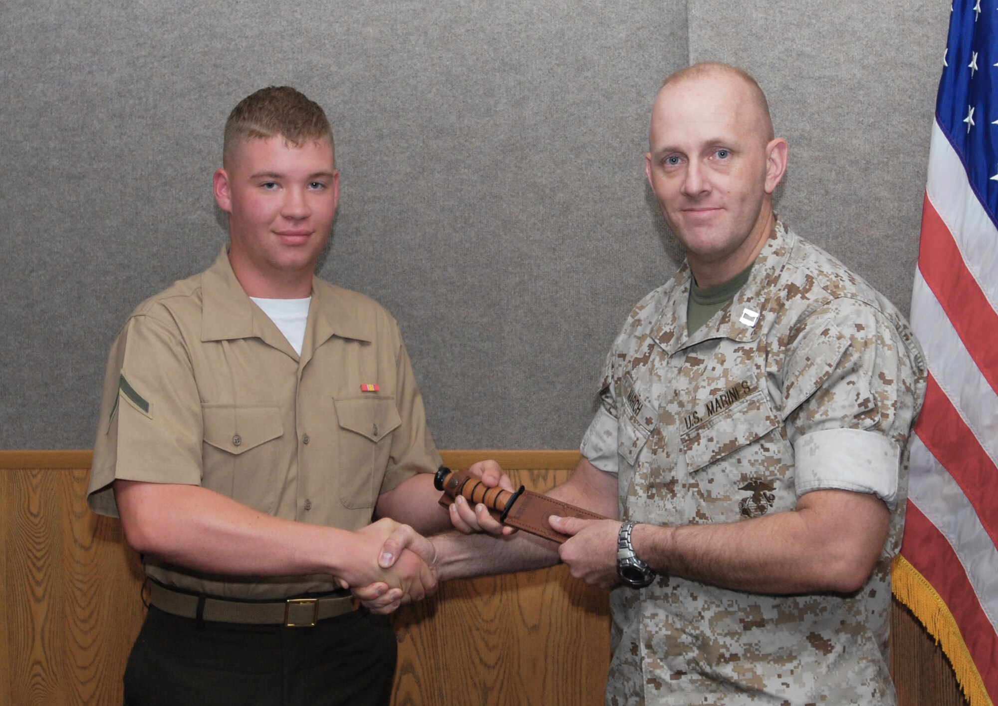 GOODFELLOW AIR FORCE BASE, Texas -- U.S. Marine Corps Pfc. Cameron Gasaway, 312th Training Squadron, receives a gift for his accomplishments from Capt. Douglas March, Marine Corps Detachment commander, May 6, 2011. (U.S. Air Force photo/Airman 1st Class Michael Smith)