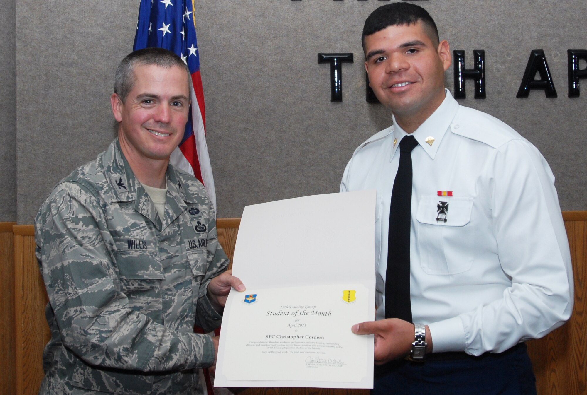 GOODFELLOW AIR FORCE BASE, Texas -- U.S. Army Spc. Christopher Cordero, 316th Training Squadron, receives Student of the Month certificate from Col. J.D. Willis, 17th Training Group commander, May 6, 2011. (U.S. Air Force photo/Airman 1st Class Michael Smith)