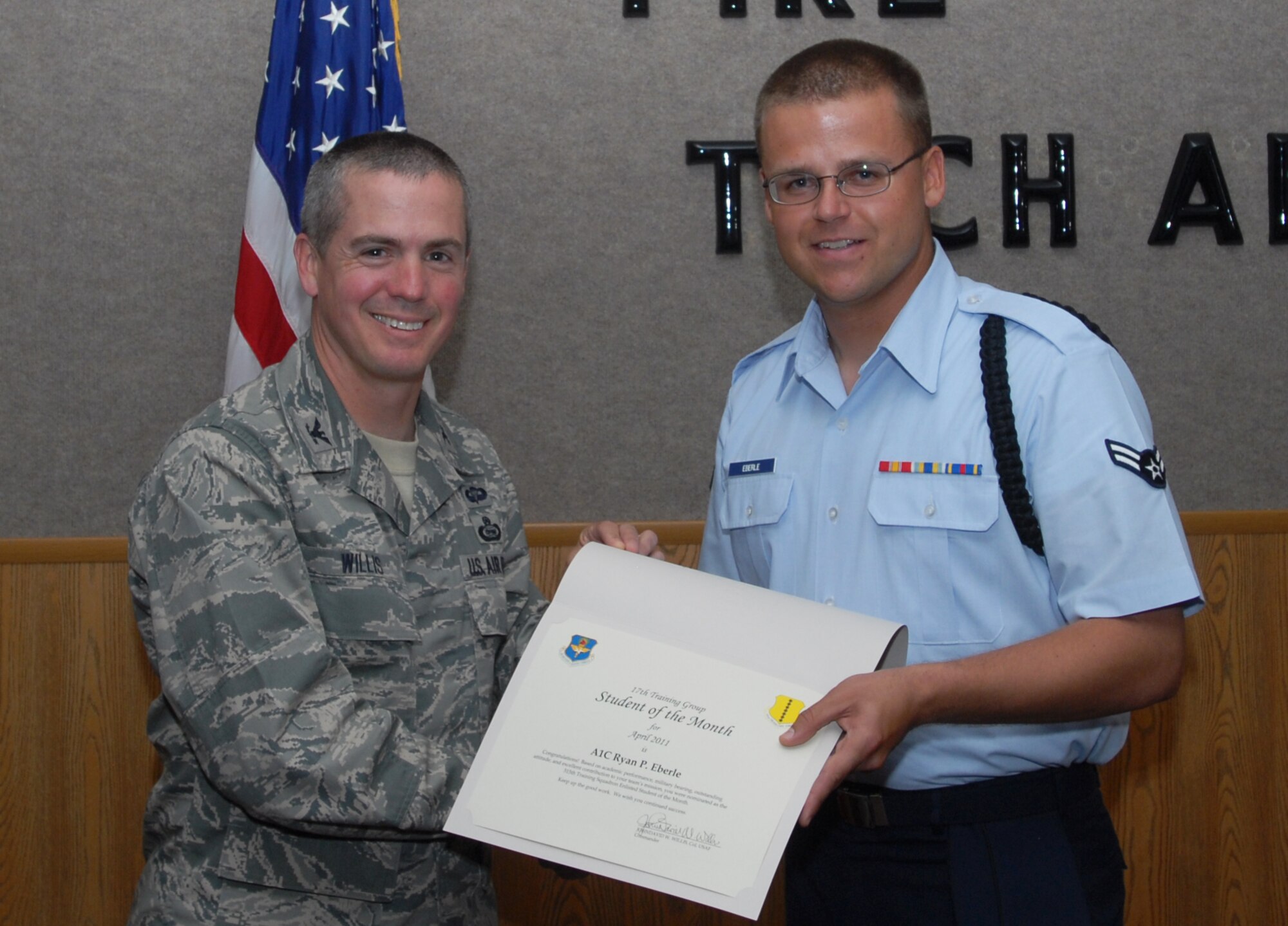 GOODFELLOW AIR FORCE BASE, Texas -- Airman 1st Class Ryan Eberle, 315th Training Squadron, receives Student of the Month certificate from Col. J.D. Willis, 17th Training Group commander, May 6, 2011. (U.S. Air Force photo/Airman 1st Class Michael Smith)