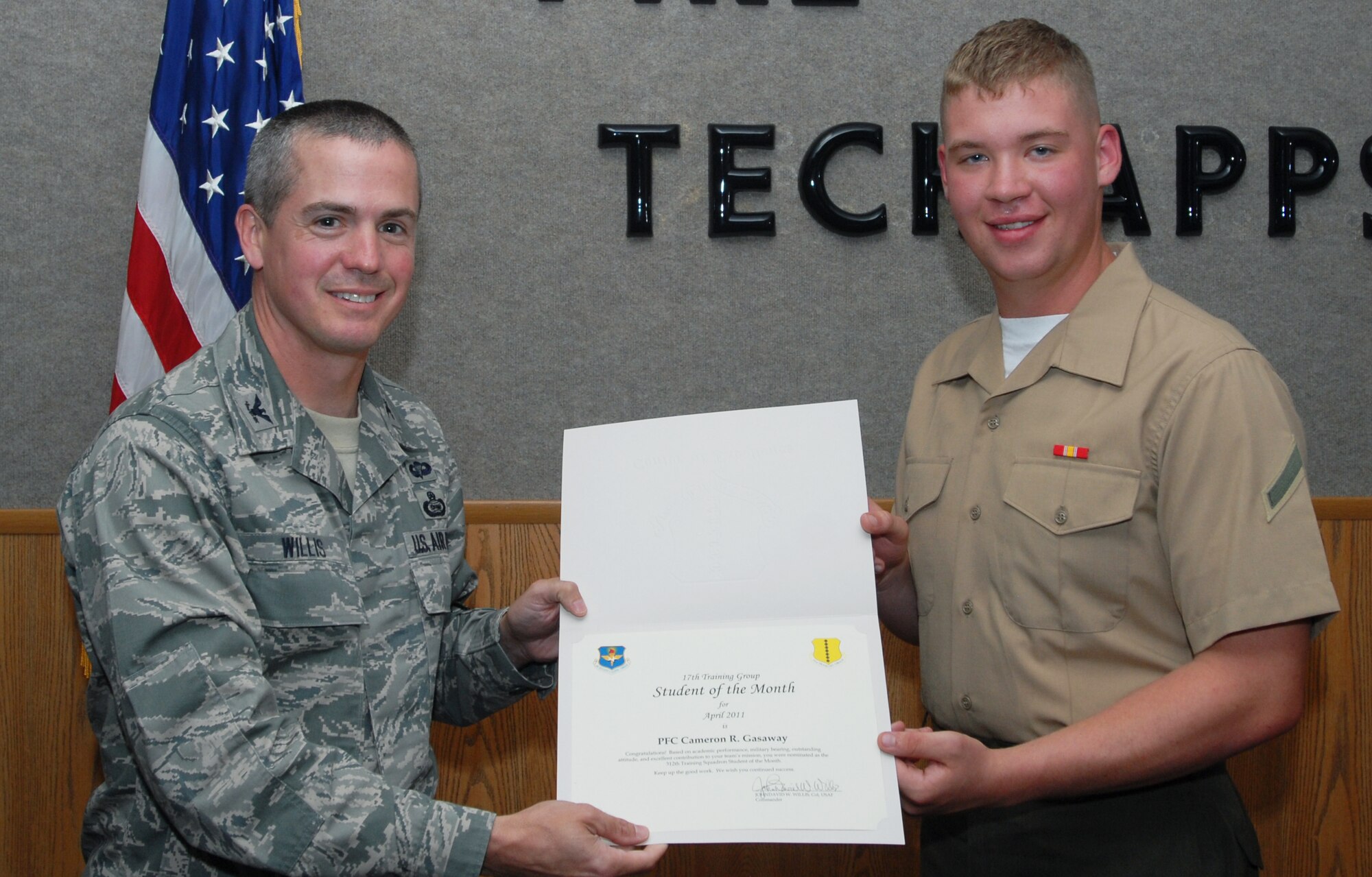 GOODFELLOW AIR FORCE BASE, Texas -- U.S. Marine Corps Pfc. Cameron Gasaway, 312th Training Squadron, receives Student of the Month certificate from Col. J.D. Willis, 17th Training Group commander, May 6, 2011. (U.S. Air Force photo/Airman 1st Class Michael Smith)