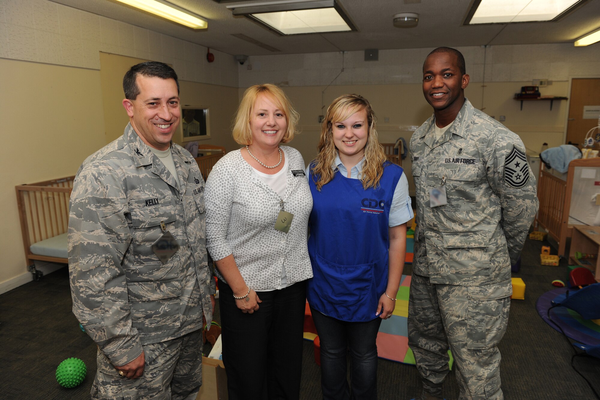 Col. Brian Kelly (far left) and Chief Master Sgt. Larence Kirby (far right) stand with Christine Kaleikini (center left) and Natasha Matthews (center right) in the RAF Alconbury Child Development Center May 6 after recognizing their efforts to support the Aviano CDC during Operations Odyssey Dawn and Unified Protector. (U.S. Air Force photo by Tech. Sgt. John Barton)