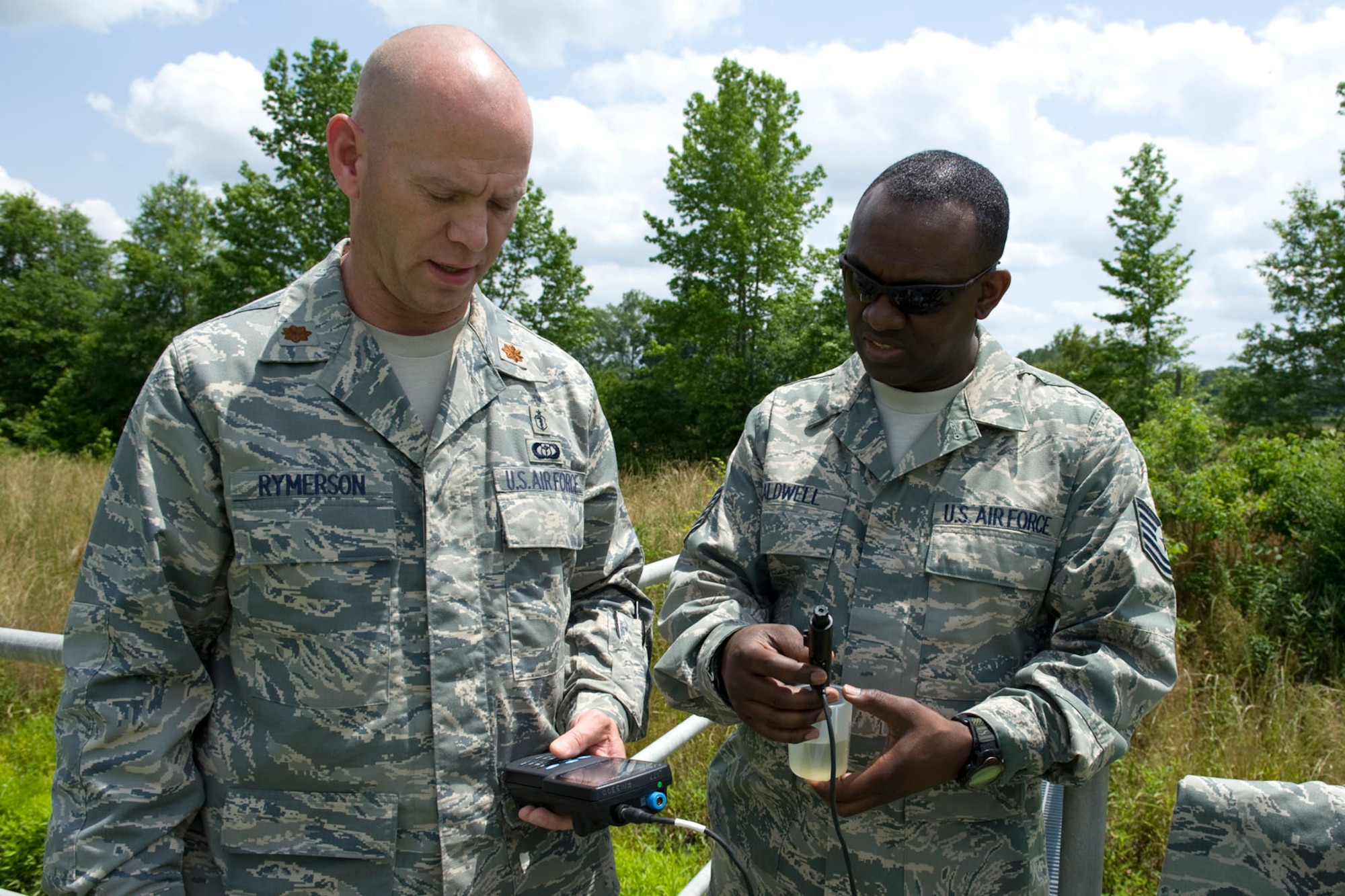 HAYNEVILLE, Ala. - Maj. Rick Rymerson, a  a bioenvironmental engineer with the 176th Medical Group, Alaska Air National Guard, and Tech. Sgt. Dainard Caldwell, a public health technician with group, test a ample of water from the City of Hayneville?s waste-water treatment lagoon for it pH balance, May 8, 2011.  Rymerson and Caldwell were in Alabama to help test the waste water for permit compliance and related treatment adjustments, and with drinking water for chlorine amount. They were also deploy with another seventy servicemembers from numerous military components and services in Hayneville for an Innovative Readiness Training (IRT) mission. The IRT program allows for real world training opportunities for military personnel while providing needed services to under-served communities in the United States. Alaska Air National Guard photo by Master Sgt. Shannon Oleson.