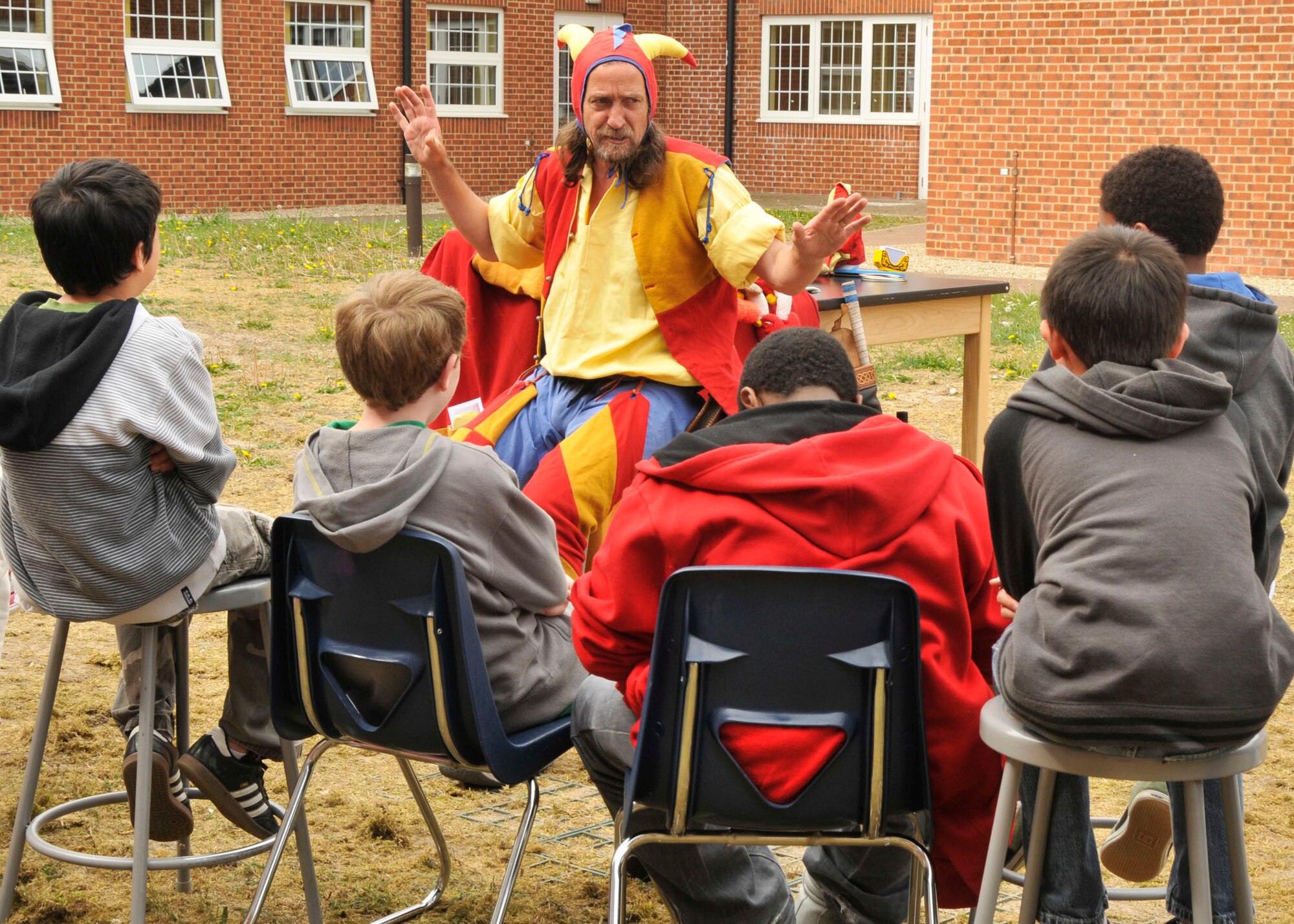 ROYAL AIR FORCE LAKENHEATH, England - Devilstick Peat, professional jester, entertains Lakenheath Middle School 6th graders at the school during U.K. Day on May 6, 2011. Mr. Peat has entertained people all over the world, including Kosovo and Iraq, with his zany humor and multitude of talents to include juggling. U.K. Day gave the students the opportunity to learn various aspects of British history and culture. (U.S. Air Force photo/Senior Airman Tiffany M. Deuel)