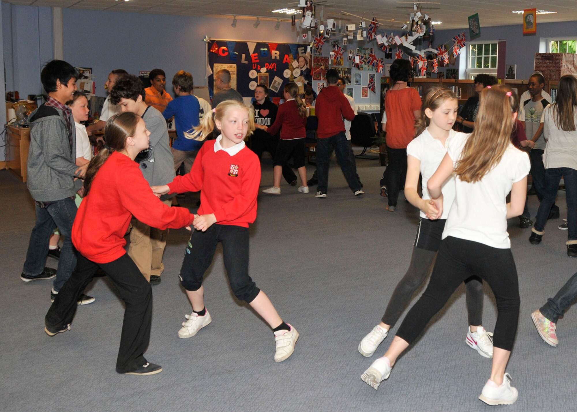 ROYAL AIR FORCE LAKENHEATH, England - Lakenheath Middle School 6th graders and Edmund De Moundeford Primary School 5th graders learn traditional English country dancing at LMS during U.K. Day on May 6, 2011. U.K. Day provided the students the opportunity to learn about the history and culture of England through activities ranging from traditional dances to making scones.  Nearly 60 British performers participated in teaching the children about England through fun activities. (U.S. Air Force photo/Senior Airman Tiffany M. Deuel)