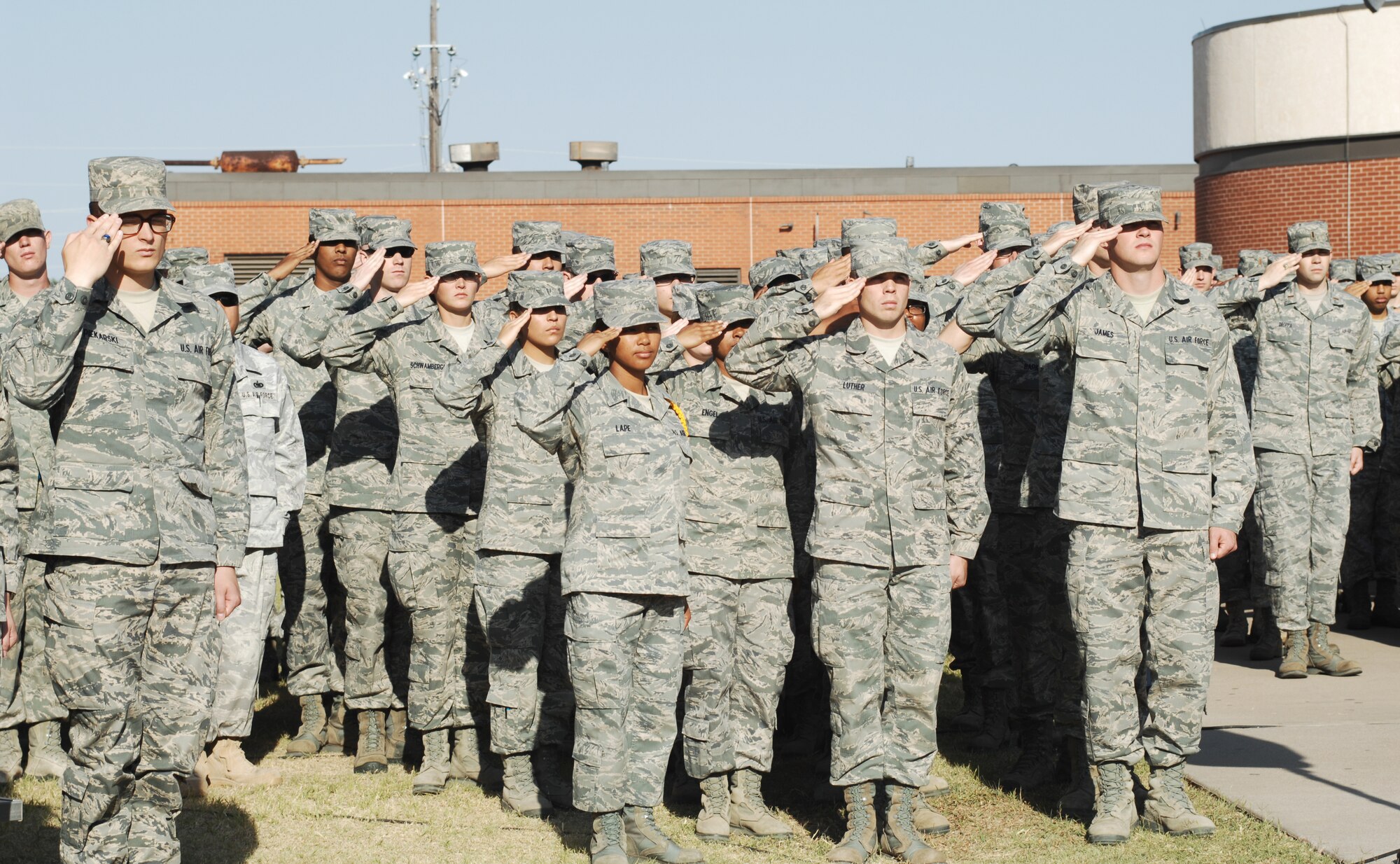GOODFELLOW AIR FORCE BASE, Texas – A crowd renders a salute during the National Anthem at the start of the building dedication ceremony April 29 which named building 525 Schulte Hall in honor of 1st Lt. Roslyn Schulte, and ISR Warrior who was killed in action during her deployment to Afghanistan in May 2009. (U.S. Air Force photo/Staff Sgt. Laura McFarlane).