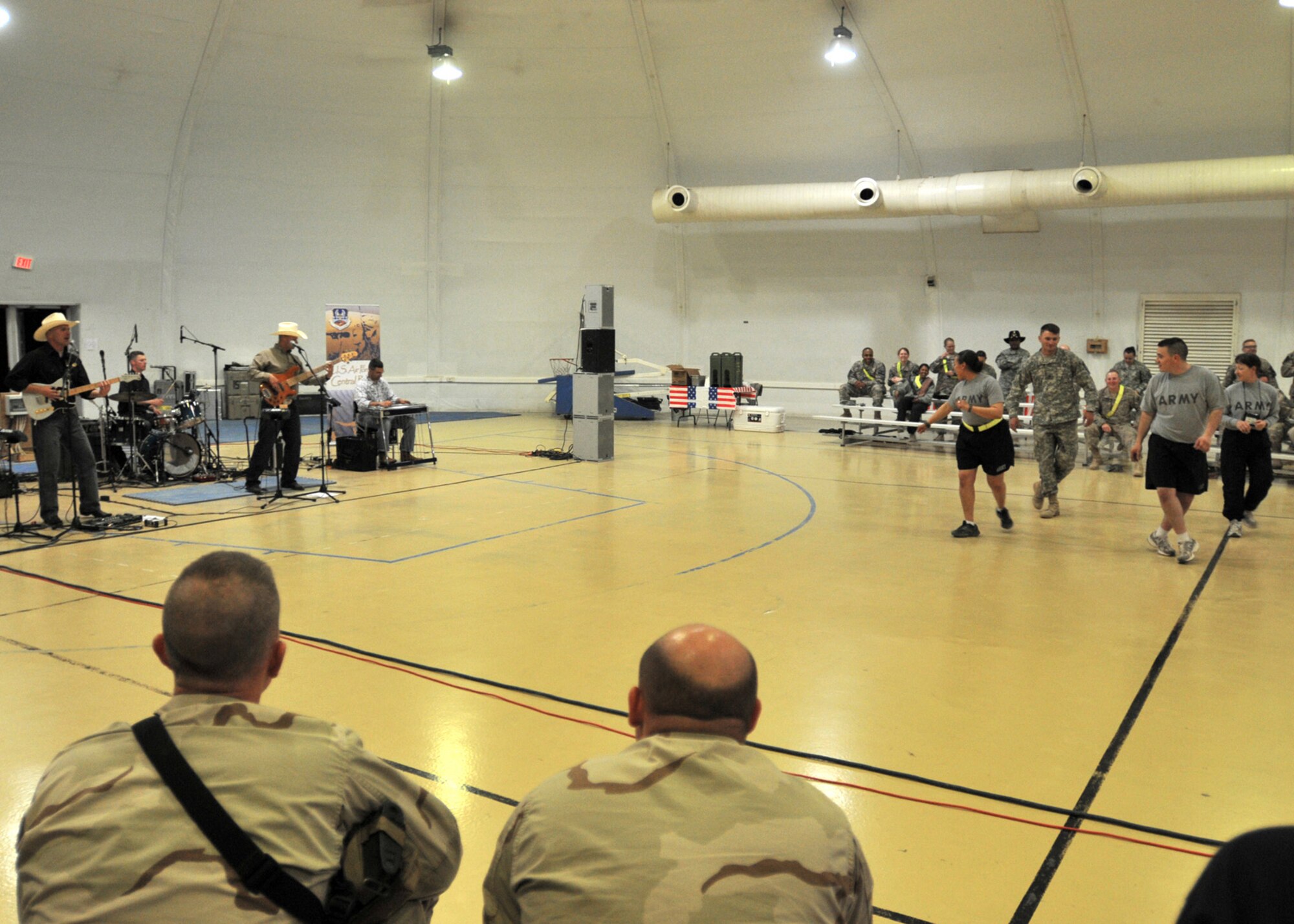 CONTINGENCY OPERATING SITE MAREZ, Iraq – Soldiers assigned to 4th Advise and Assist Brigade, 1st Cavalry Division, line dance to a rendition of “Sweet Home Alabama” performed by the U.S. Air Force’s Central band, "Wild Blue Country" during a concert at the Contingency Operating Site Marez gym, April 29, 2011. The Air Force band from Colorado Springs, Colo. performed popular country songs during a two-hour concert for the deployed Fort Hood troopers and civilians. (U.S. Army photo by Spc. Terence Ewings, 4th AAB PAO, 1st Cav. Div., USD-N)
