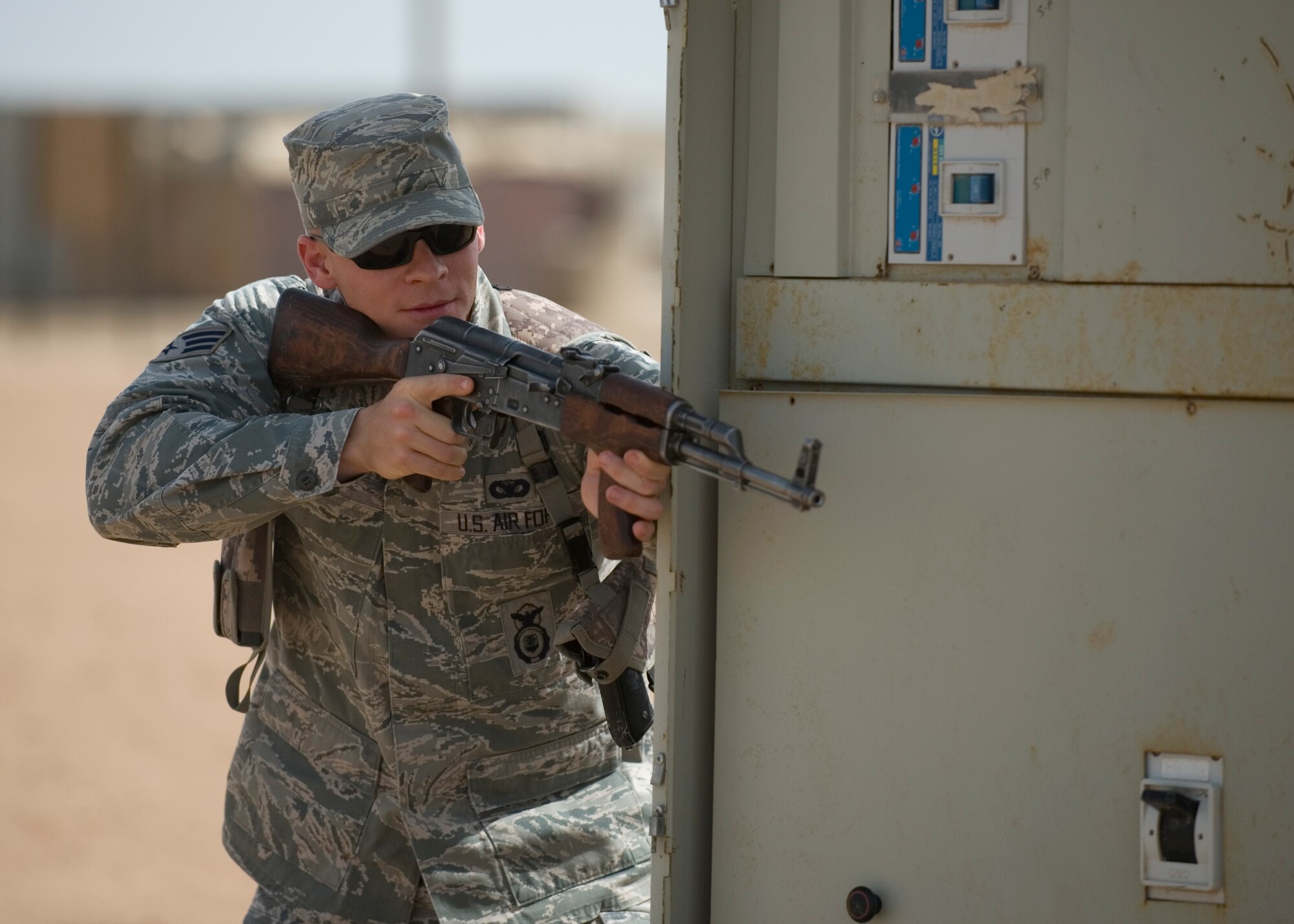 ALI AIR BASE, Iraq -- Senior Airman Chris Kelly, 407th Expeditionary Security Forces Squadron, takes cover during a demonstration for an Iraqi security forces class April 19. The class, the fourth one conducted in the past three months, was to familiarize Iraqi air force members with force protection measures in order to protect their own assets when U.S. forces transition out. Airman Kelly is deployed from Lackland Air Force Base, Texas, and is a native of Pensacola, Fla. (U.S. Air Force photo by Staff Sgt. Levi Riendeau)
