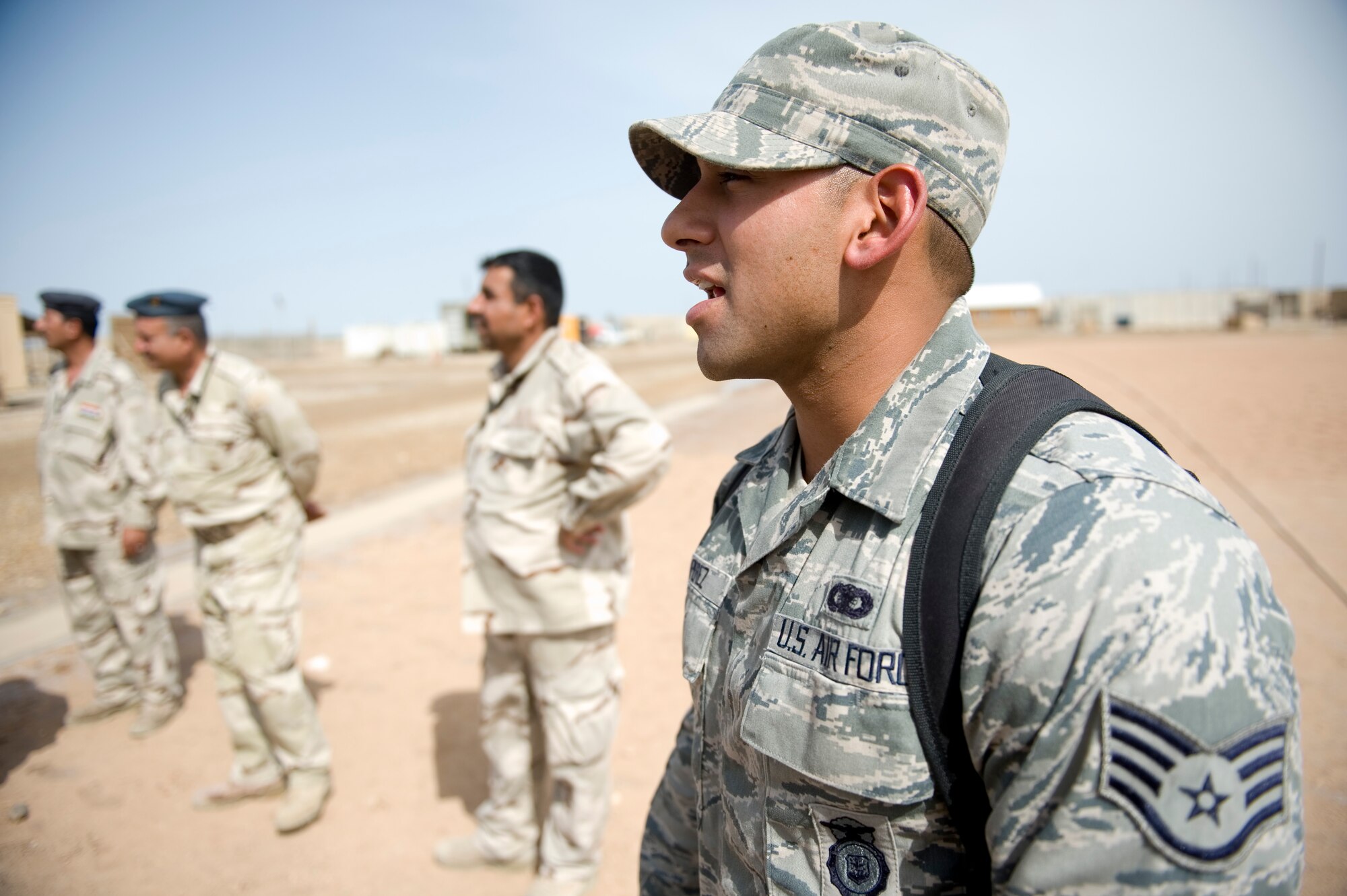 ALI AIR BASE, Iraq -- Staff Sgt. Cody Perez, 407th Expeditionary Security Forces Squadron, calls out commands to Iraqi security forces students during practical drills of force protection measures April 19. The class, the fourth one conducted during the past three months, was to familiarize Iraqi air force members with force protection measures in order to protect their own assets when U.S. forces transition out. Sergeant Perez is deployed from Lackland Air Force Base, Texas, and is a Franklin, Texas, native. (U.S. Air Force photo by Staff Sgt. Levi Riendeau)
