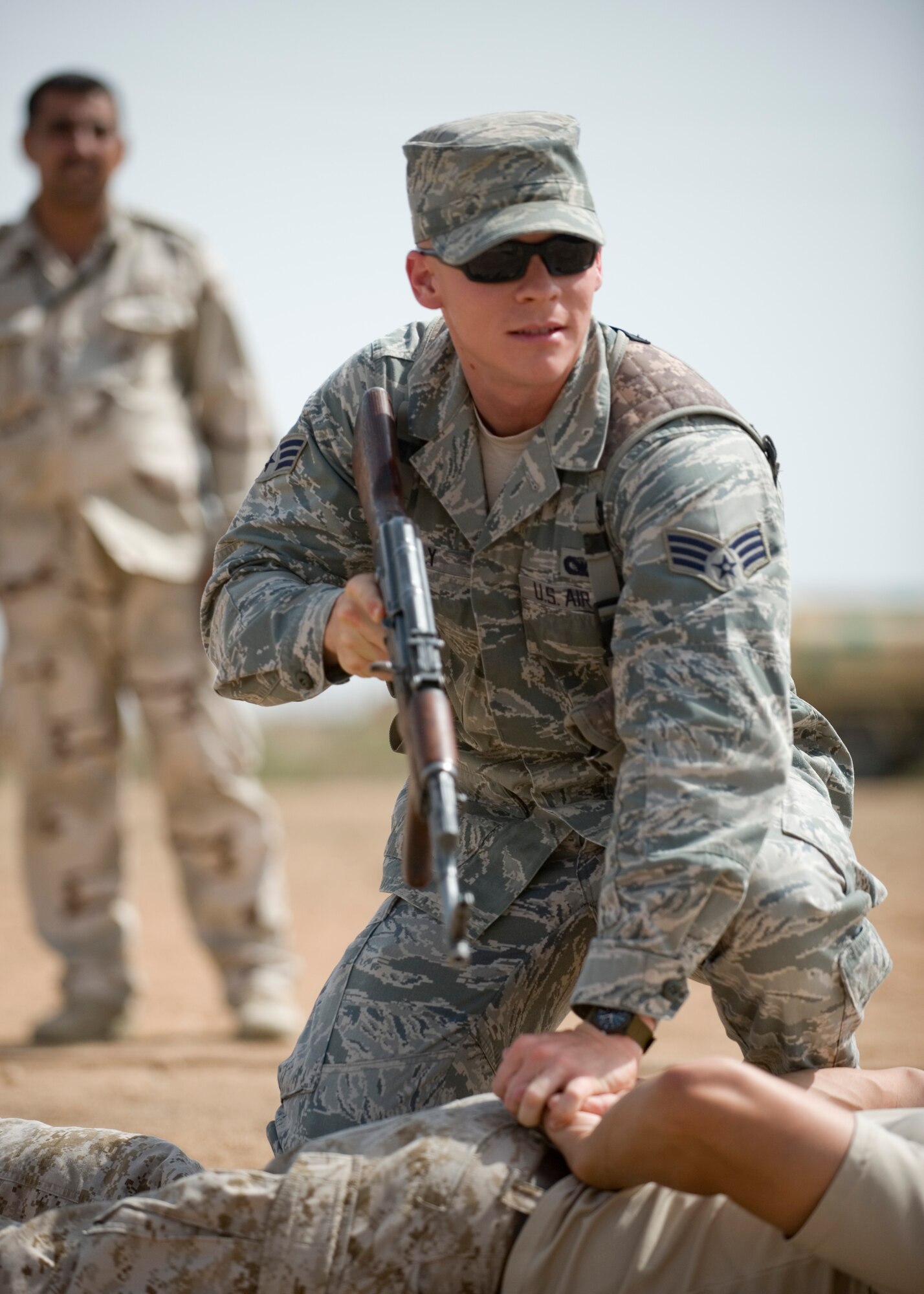ALI AIR BASE, Iraq -- Senior Airman Chris Kelly, 407th Expeditionary Security Forces Squadron, takes down a trespasser during a demonstration for an Iraqi security forces class April 19. The class, the fourth one conducted during the past three months, was to familiarize Iraqi air force members with force protection measures in order to protect their own assets when U.S. forces transition out. Airman Kelly is deployed from Lackland Air Force Base, Texas, and is a native of Pensacola, Fla. (U.S. Air Force photo by Staff Sgt. Levi Riendeau)
