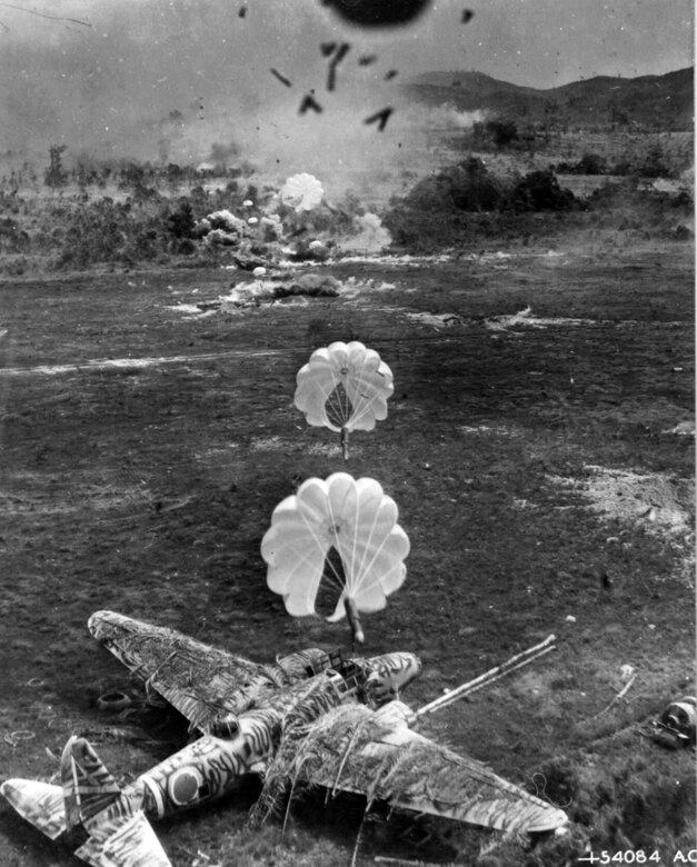 Seconds after the destruction of a Douglas A-20, the 
camouflaged Japanese "Betty" bomber was destroyed by parafrag bombs during a low-level attack on the airdrome. (U.S. Air Force photo)