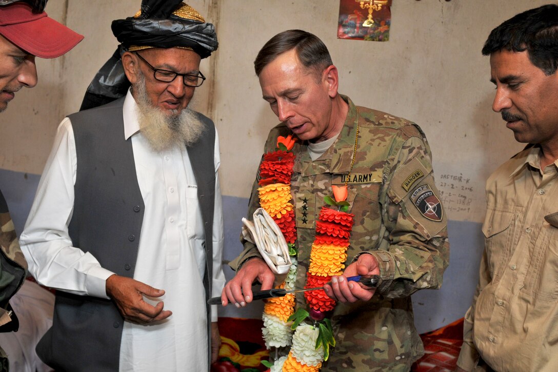 U.S. Army Gen. David H. Petraeus, commander of U.S. and international forces in Afghanistan, talks with a resident in Qalat Mangwal, Afghanistan, May 8, 2011, during a battlefield circulation to visit the 1st Battalion, 16th Infantry Regiment.