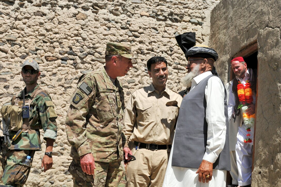U.S. Army Gen. David H. Petraeus, commander of U.S. and international forces in Afghanistan, talks with residents in Qalat Mangwal, Afghanistan, May 8, 2011, during his visit with the 1st Battalion, 16th Infantry Regiment.