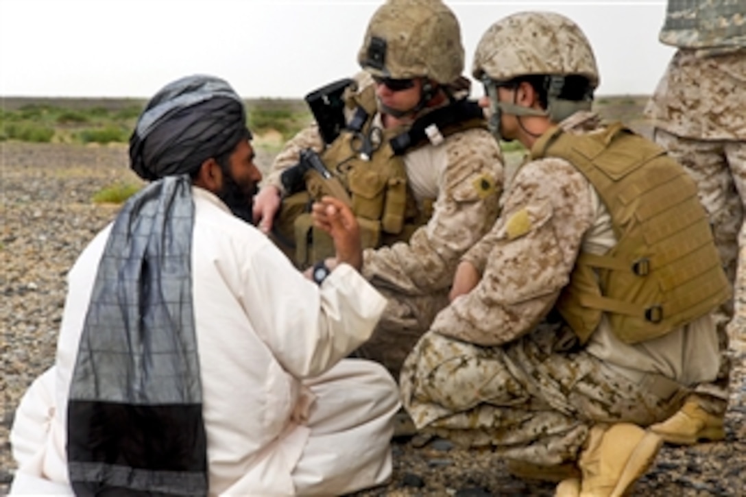 U.S. Marines talk with an Afghan civilian during an aerial interdiction mission in southwestern Afghanistan on May 4, 2011.  The Marines are assigned to Regimental Combat Team 1.  