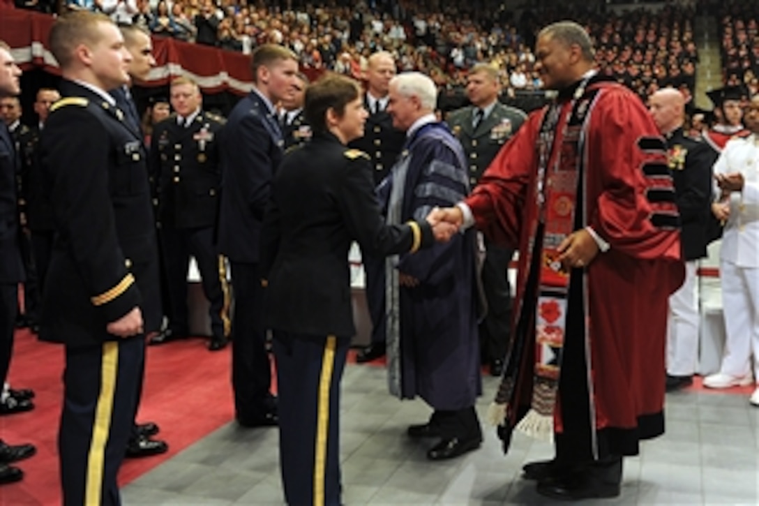 Secretary of Defense Robert M. Gates and University President Elson S. Floyd congratulate ROTC cadets on their enlistment during the Washington State University Commencement ceremony in Pullman, Wash., on May 7, 2011.  