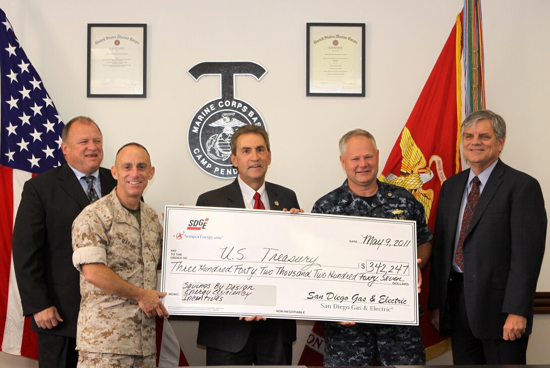 Mike Fleming, senior account executive, San Diego Gas and Electric, Col. Nicholas F. Marano, commanding officer, Marine Corps Base Camp Pendleton, David Geier, vice president of electric operations, SDG&E, Capt. Mike Williamson, officer-in-charge of construction, MCB Camp Pendleton and Dave Guebert, manager, SDG&E present a check to be used for MCB Camp Pendleton. The money is part of savings the Marine Corps contributed, by building energy-conserving buildings focusing on long-term cost benefits on Camp Pendleton.