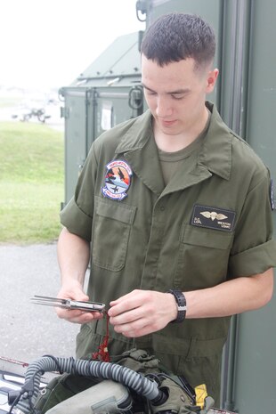 Lance Cpl. Drew C. Weston, a Marine All Weather Attack Squadron 533 flight equipment technician, checks the multi-purpose tool in a flight jacket of one of VMFA(AW)-533's pilots here May 9. The pilots are allowed to have up to five pounds of extra gear in their flight jackets.