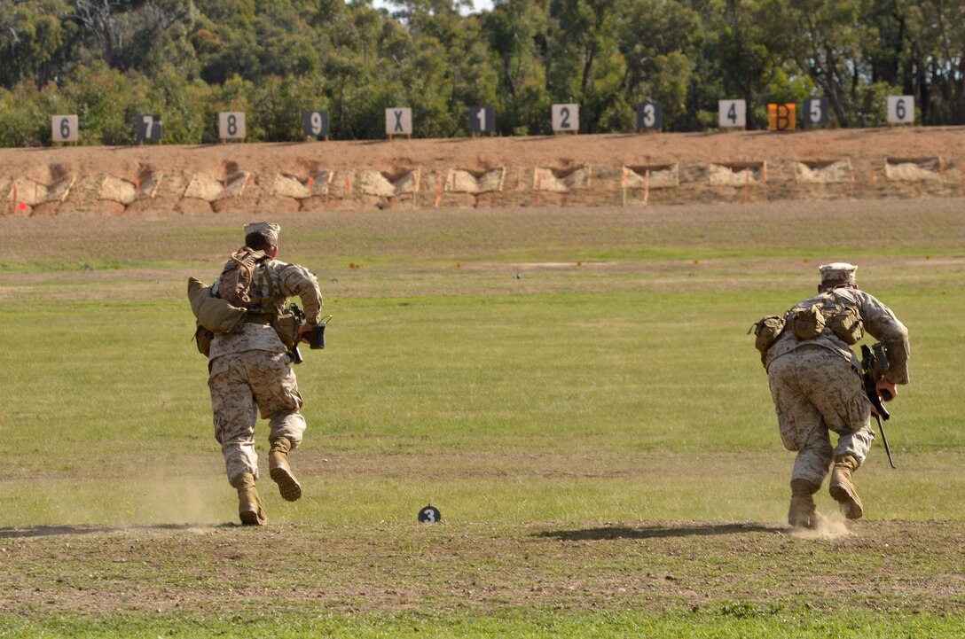 Lance Cpl. Pete Shea (left), rifleman, and Cpl. Duane Kamps (right) mortarman, both with 3rd Battalion, 3rd Marine Regiment, 3rd Marine Division, sprint toward the firing line May 10 during the 2011 Australian Army Skill at Arms Meeting.  The meeting is an annual, international combat-marksmanship competition hosted by the Australian Army that will run through May 19.  (U.S. Marine Corps Photo by Lance Cpl. Mark W. Stroud/Released)